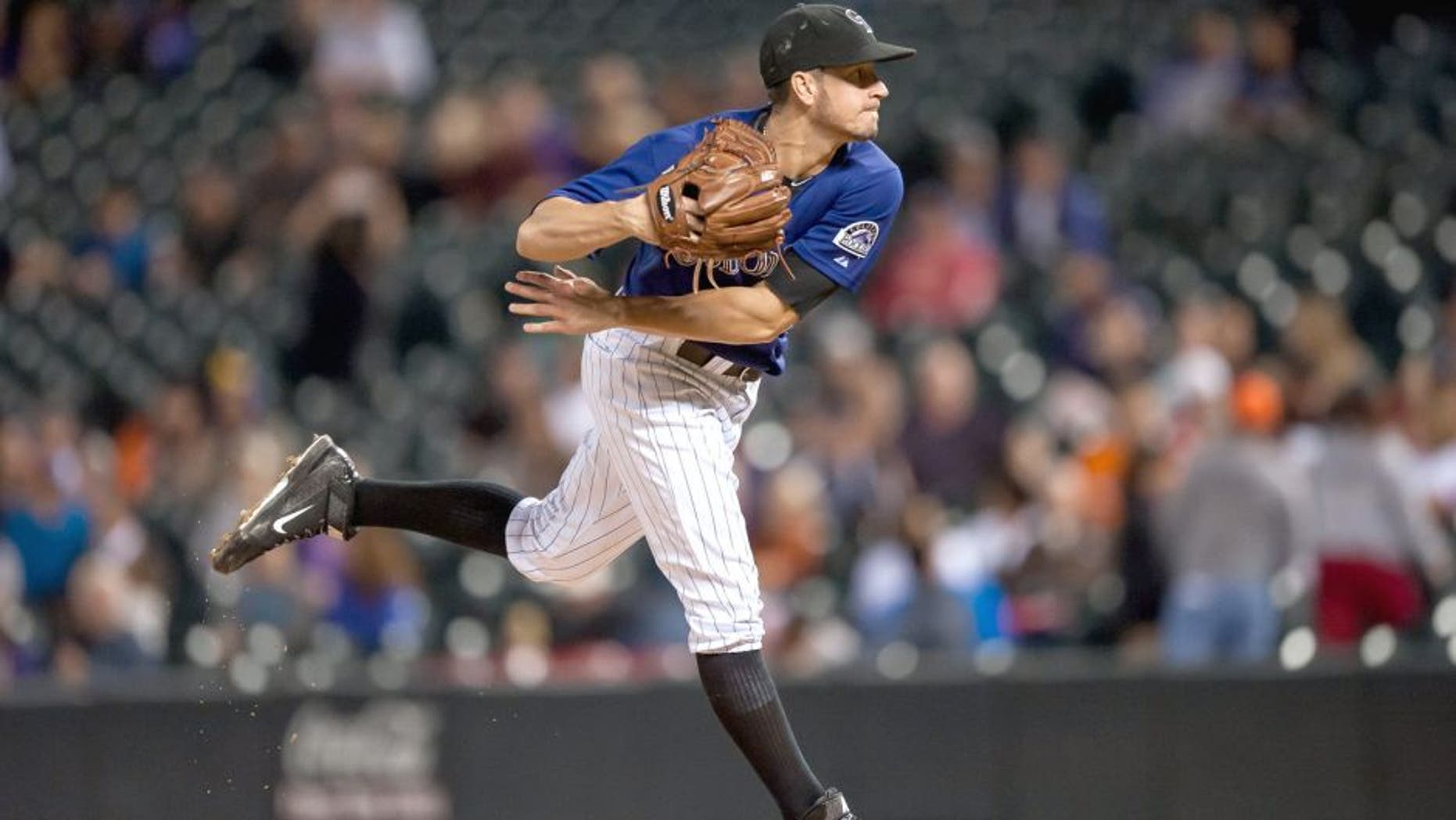DENVER, CO - SEPTEMBER 3: Chris Rusin #52 of the Colorado Rockies pitches against the San Francisco Giants in the ninth inning during a game at Coors Field on September 3, 2015 in Denver, Colorado. Rusin pitched a complete game allowing 6 hits and 2 runs. (Photo by Dustin Bradford/Getty Images)