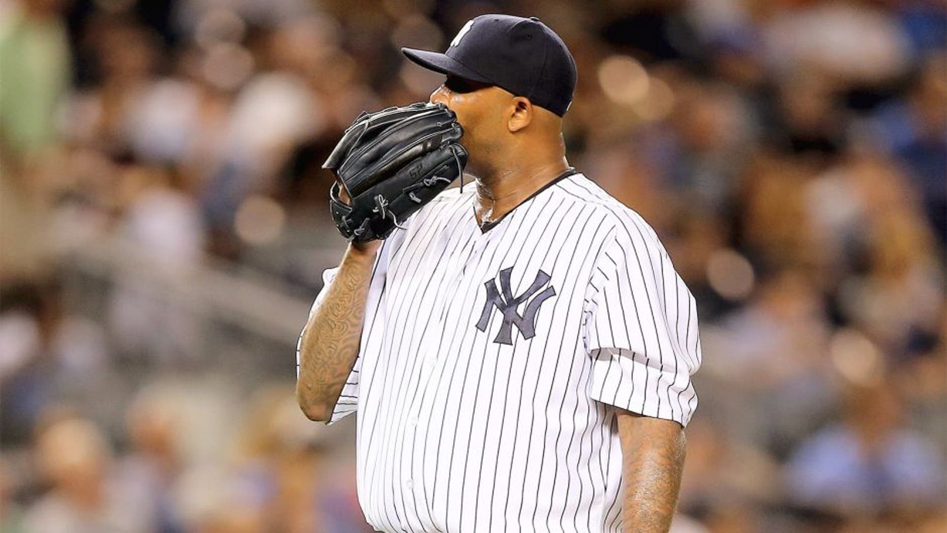 NEW YORK, NY - AUGUST 18: CC Sabathia #52 of the New York Yankees reacts after Miguel Sano of the Minnesota Twins hit a two run home run in the seventh inning on August 18, 2015 at Yankee Stadium in the Bronx borough of New York City. (Photo by Elsa/Getty Images)