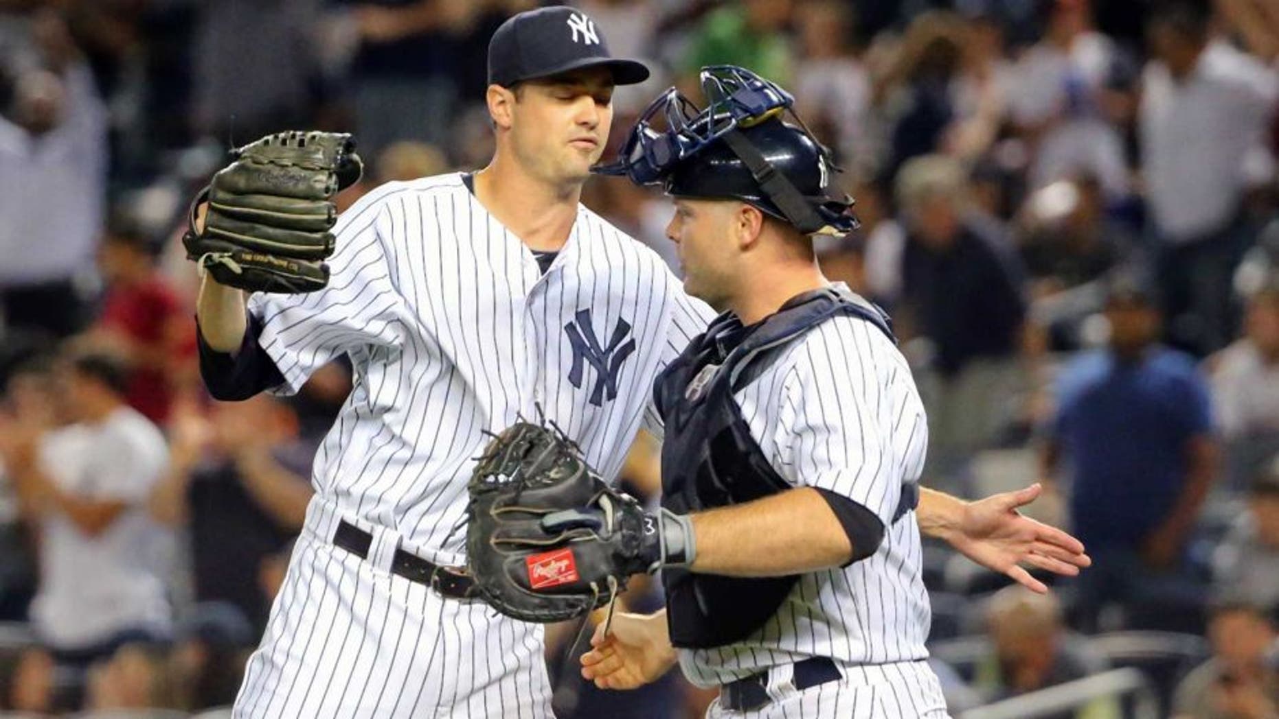 Sep 4, 2015; Bronx, NY, USA; New York Yankees relief pitcher Andrew Miller (48) and catcher Brian McCann (34) celebrate the win against the Tampa Bay Rays at Yankee Stadium. New York Yankees won 5-2. Mandatory Credit: Anthony Gruppuso-USA TODAY Sports