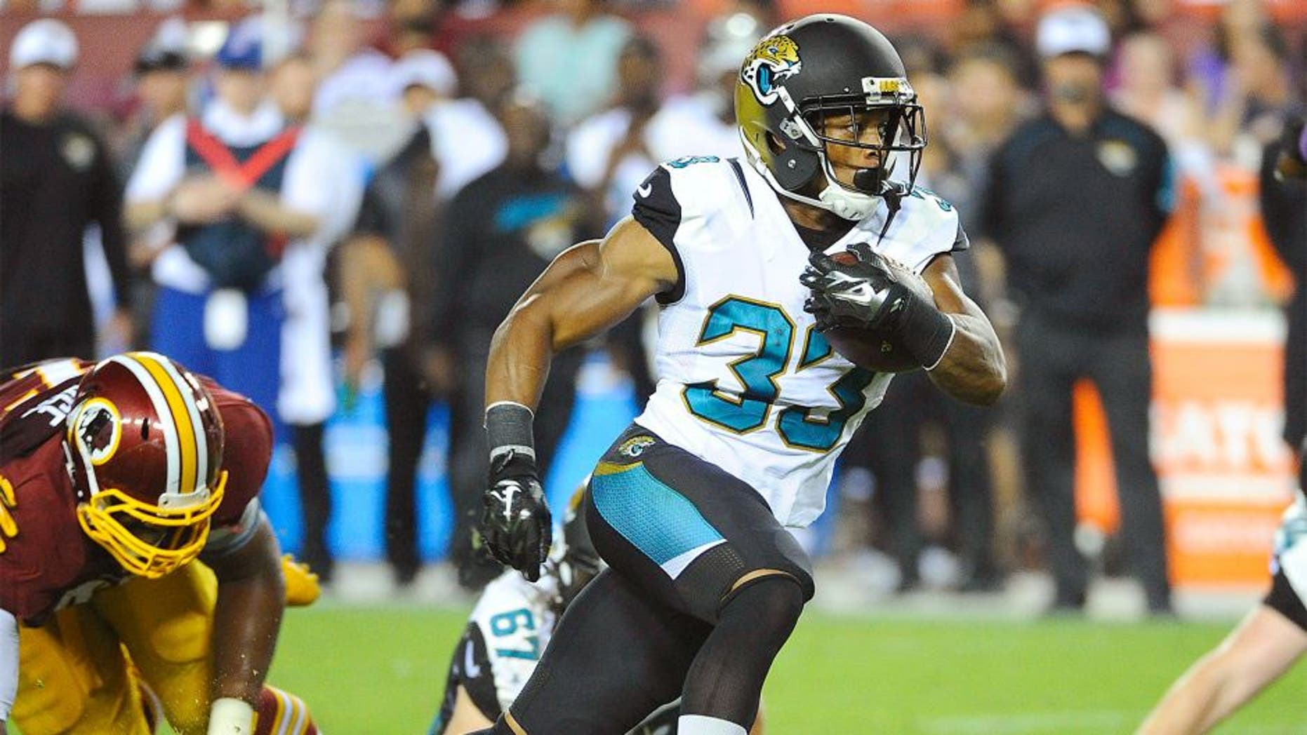 Sep 3, 2015; Landover, MD, USA; Jacksonville Jaguars running back Corey Grant (33) rushes the ball against the Washington Redskins during the second half at FedEx Field. The Jacksonville Jaguars won 17 - 16. Mandatory Credit: Brad Mills-USA TODAY Sports