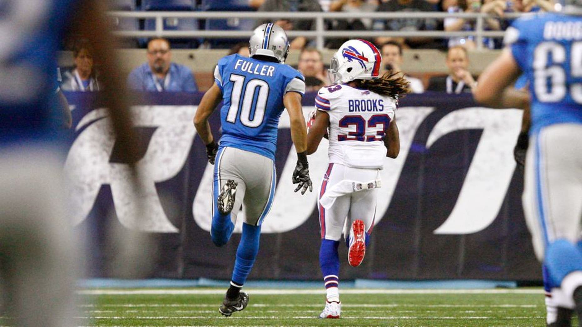 Sep 3, 2015; Detroit, MI, USA; Buffalo Bills cornerback Ron Brooks (33) makes an interception for a touchdown and is chased by Detroit Lions wide receiver Corey Fuller (10) during the first quarter of a preseason NFL football game at Ford Field. Mandatory Credit: Raj Mehta-USA TODAY Sports