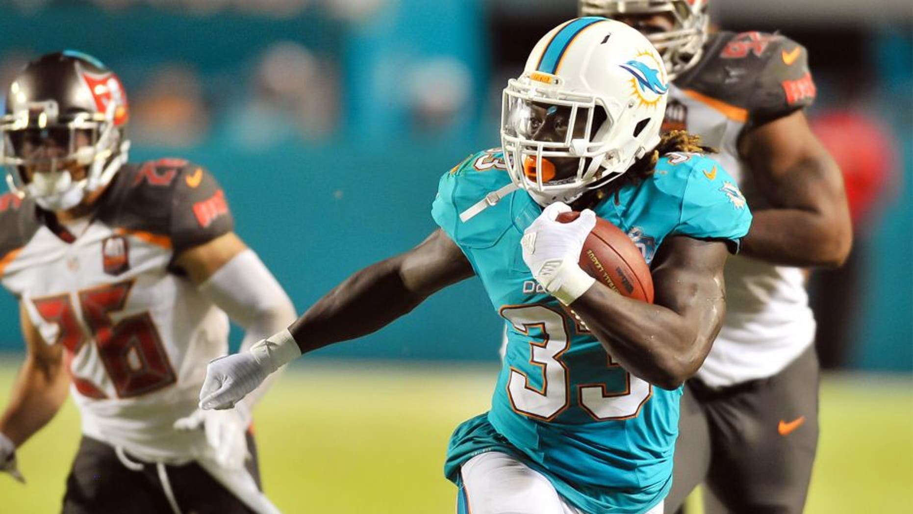 Sep 3, 2015; Miami Gardens, FL, USA; Miami Dolphins running back Jay Ajayi (33) runs against the Tampa Bay Buccaneers during the first half at Sun Life Stadium. Mandatory Credit: Steve Mitchell-USA TODAY Sports