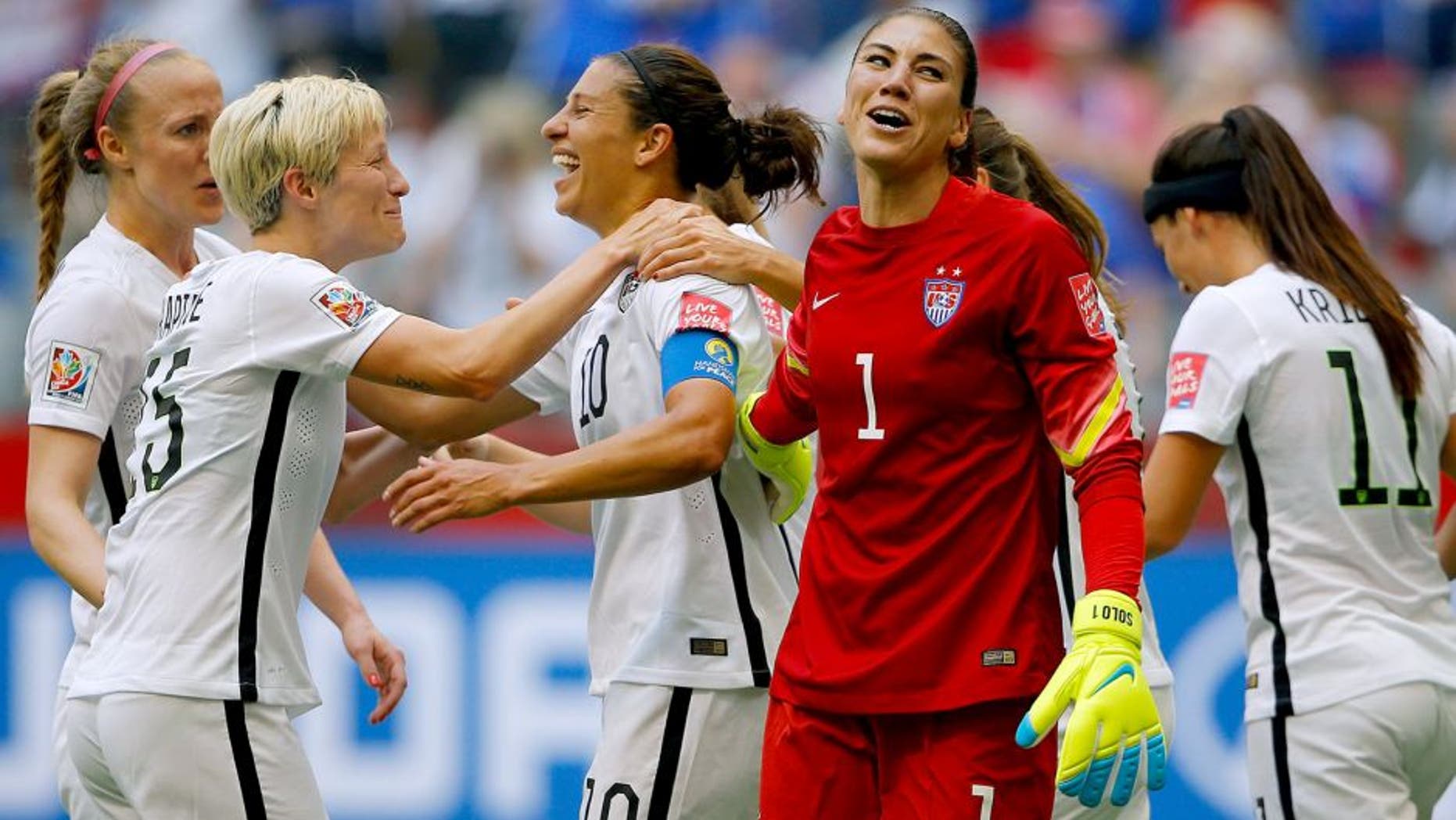 VANCOUVER, BC - JULY 05: Carli Lloyd #10 of the United States of America celebrates after her third goal against Japan with goalkeeper Hope Solo #1 and Megan Rapinoe #15 in the FIFA Women's World Cup Canada 2015 Final at BC Place Stadium on July 5, 2015 in Vancouver, Canada. (Photo by Kevin C. Cox/Getty Images)