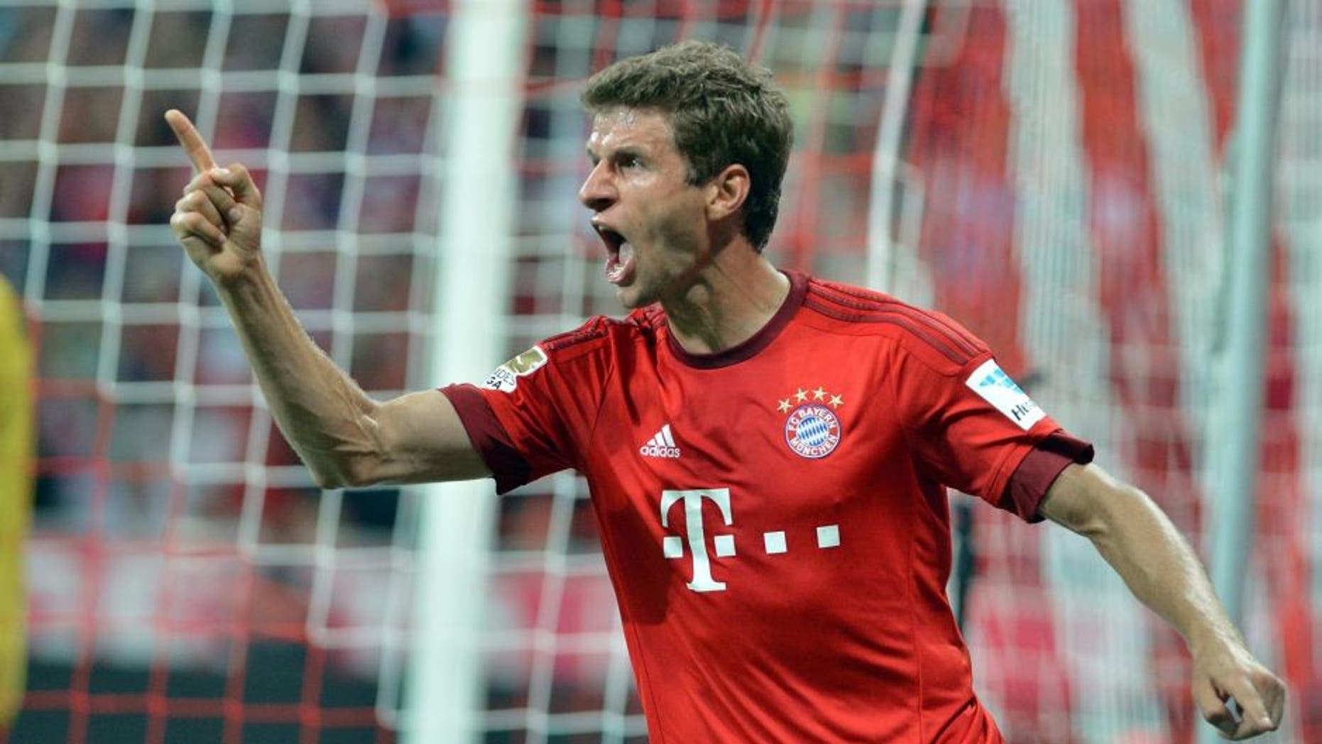 MUNICH, GERMANY - AUGUST 14: Thomas Mueller of Munich celebrates after scoring a goal during the German Bundesliga soccer match between Bayern Munich and Hamburger SV at the Allianz Arena in Munich, Germany on August 14, 2015. (Photo by Joerg Koch/Anadolu Agency/Getty Images)