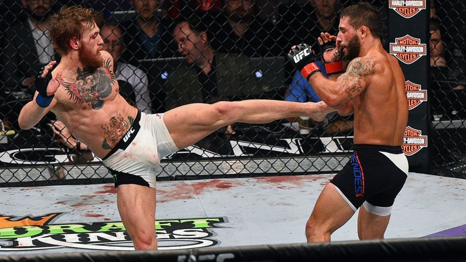 LAS VEGAS, NV - JULY 11: (L-R) Conor McGregor kicks Chad Mendes during the UFC 189 event inside MGM Grand Garden Arena on July 11, 2015 in Las Vegas, Nevada. (Photo by Jeff Bottari/Zuffa LLC/Zuffa LLC via Getty Images)