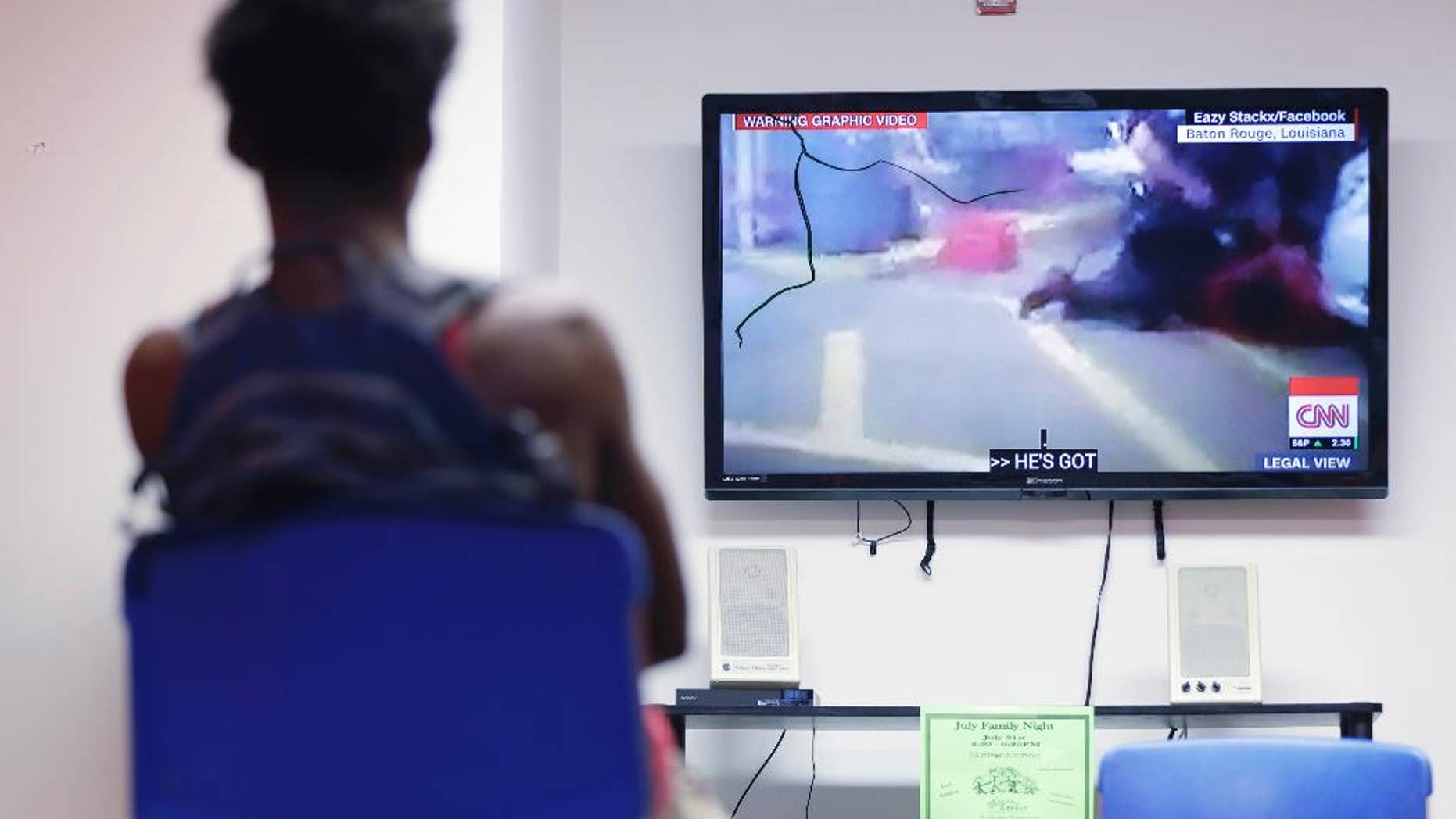 In this July 6, 2016, photo, a teen views a recording of the fatal police involved shooting in Louisiana, during a weekly mentoring meeting at The Bridge, a youth intervention and diversion program in Philadelphia. A group of black boys met with their mentors in Philadelphia to discuss one of the latest incidents at the start of what would be a week of violence ending with two black men dead and five Dallas police officers killed by a sniper. (AP Photo/Matt Rourke)