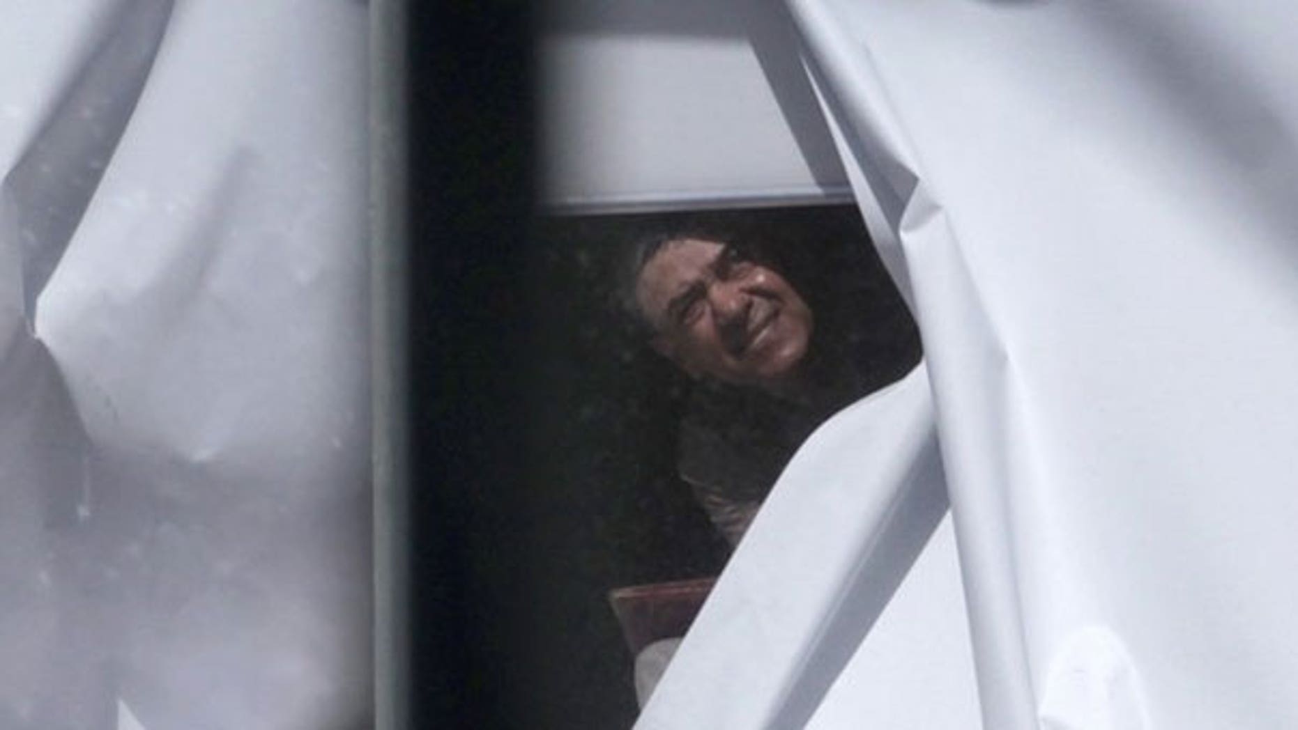 Sept. 6: A man believed to have strapped what appeared to be a bomb to himself looks out of a window next to the Parramatta court building near Sydney.