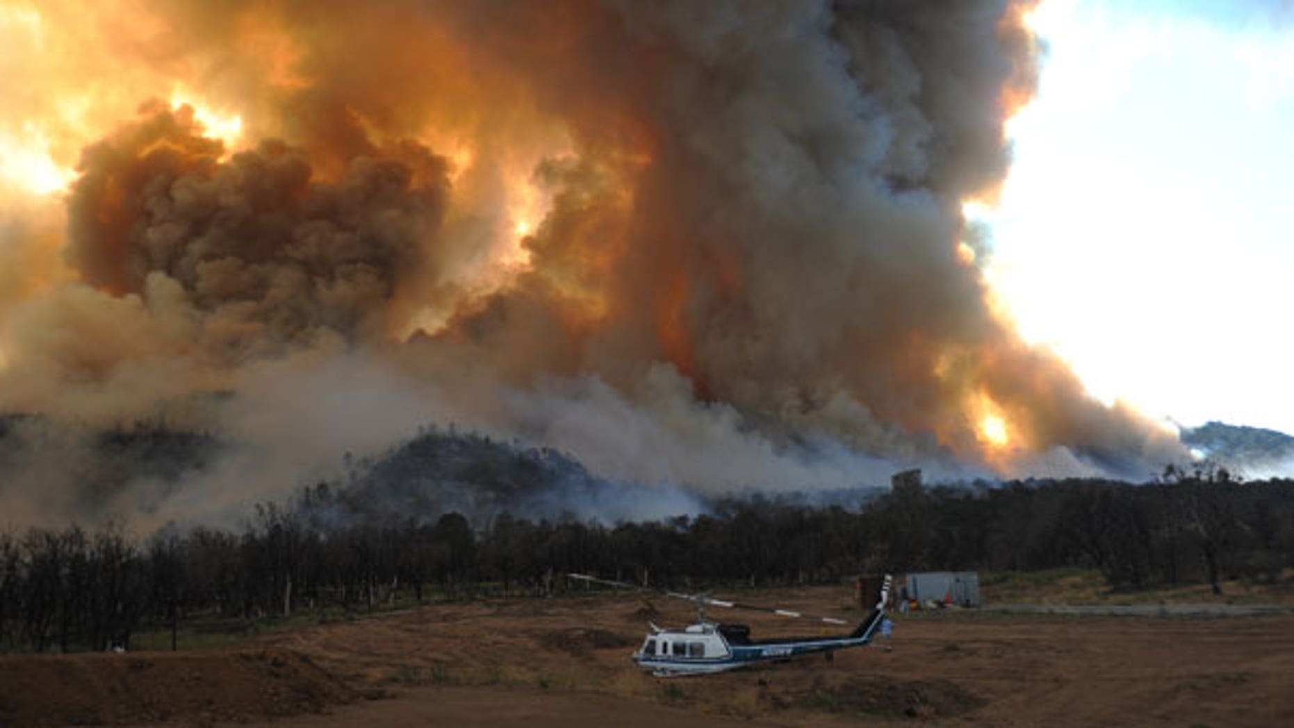 Sept. 4: A damaged helicopter sits as a large wildfire burns to the southwest of Tehachapi, Calif.
