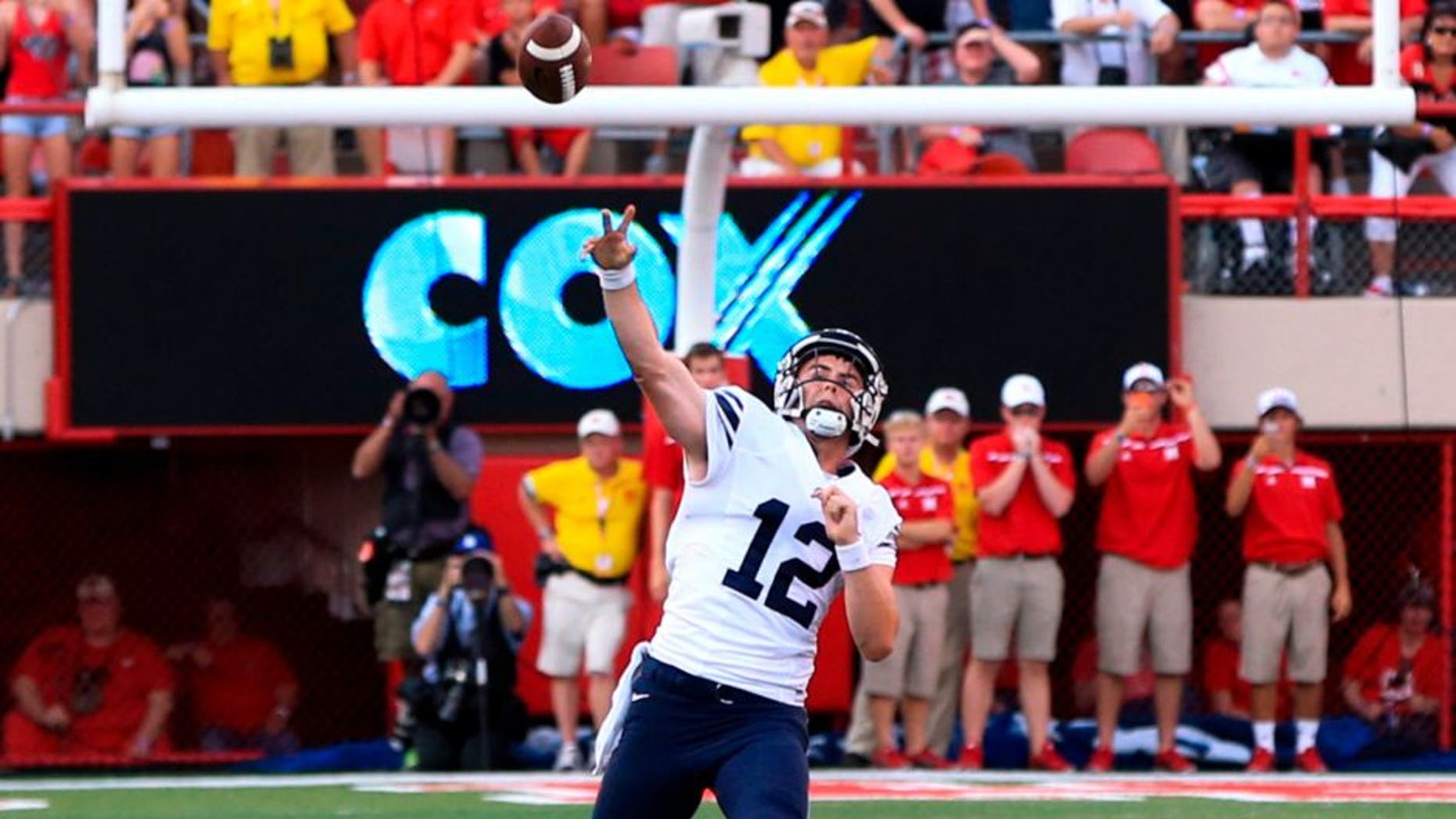 BYU quarterback Tanner Mangum throws a 42-yard Hail Mary with no time left, which was caught for the game-winning touchdown by wide receiver Mitch Mathews, unseen, giving BYU a 33-28 victory over Nebraska in an NCAA college football game in Lincoln, Neb., Saturday, Sept. 5, 2015. (AP Photo/Nati Harnik)