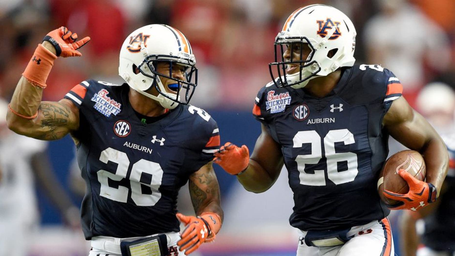 Sep 5, 2015; Atlanta, GA, USA; Auburn Tigers linebacker Justin Garrett (26) celebrates his 82 yard fumble recovery for a touchdown with Tray Matthews (28) against the Louisville Cardinals in the 2015 Chick-fil-A Kickoff Game at the Georgia Dome. Mandatory Credit: John David Mercer-USA TODAY Sports