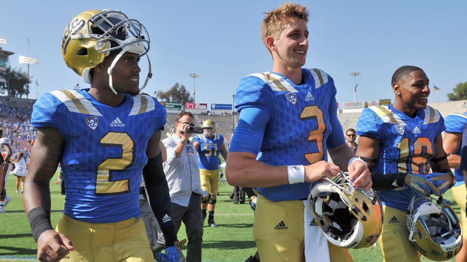 September 5, 2015; Pasadena, CA, USA; UCLA Bruins quarterback Josh Rosen (3), wide receiver Jordan Lasley (2) and defensive back Octavius Spencer (18) following the 34-16 victory against the Virginia Cavaliers at the Rose Bowl. Mandatory Credit: Gary A. Vasquez-USA TODAY Sports