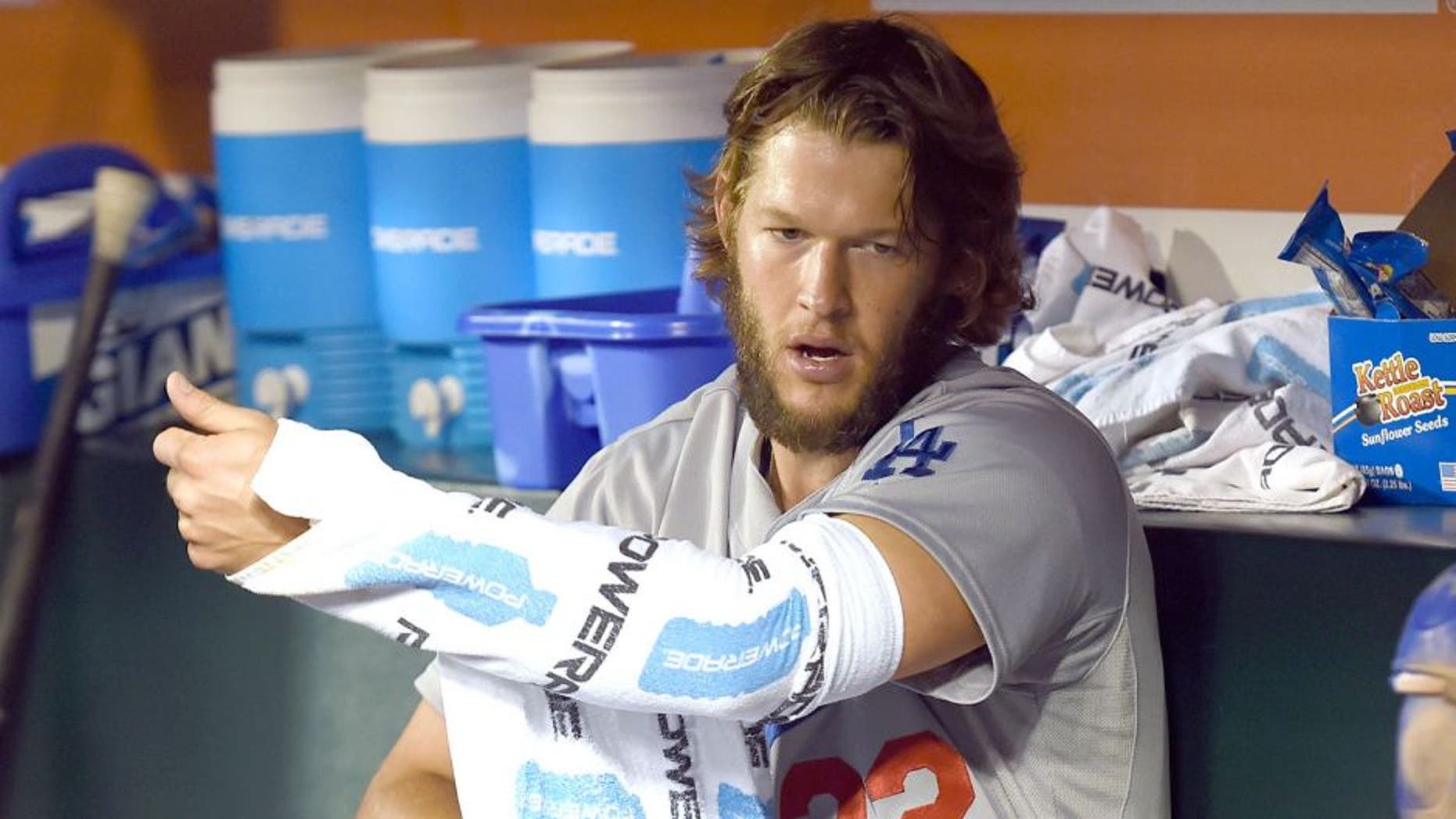 SAN FRANCISCO, CA - SEPTEMBER 29: Clayton Kershaw #22 of the Los Angeles Dodgers wraps his pitching arm up with towels to keep it warm while sitting in the dugout in the top of the ninth inning against the San Francisco Giants at AT&T Park on September 29, 2015 in San Francisco, California. (Photo by Thearon W. Henderson/Getty Images)