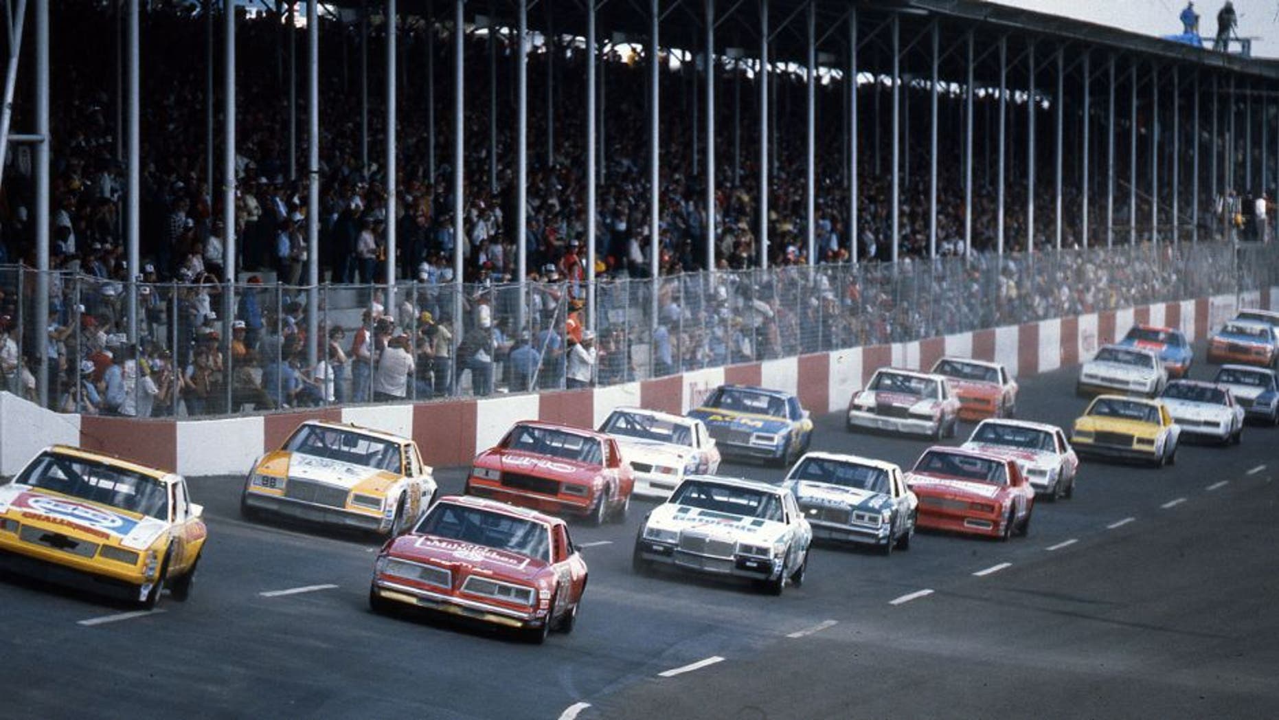 DARLINGTON, SC - APRIL 10, 1983: Darrell Waltrip (No. 11) pulls ahead of pole sitter Tim Richmond (No. 27) as the field heads toward turn one at the start of the TranSouth 500 at Darlington Raceway. (Photo by ISC Images & Archives via Getty Images)