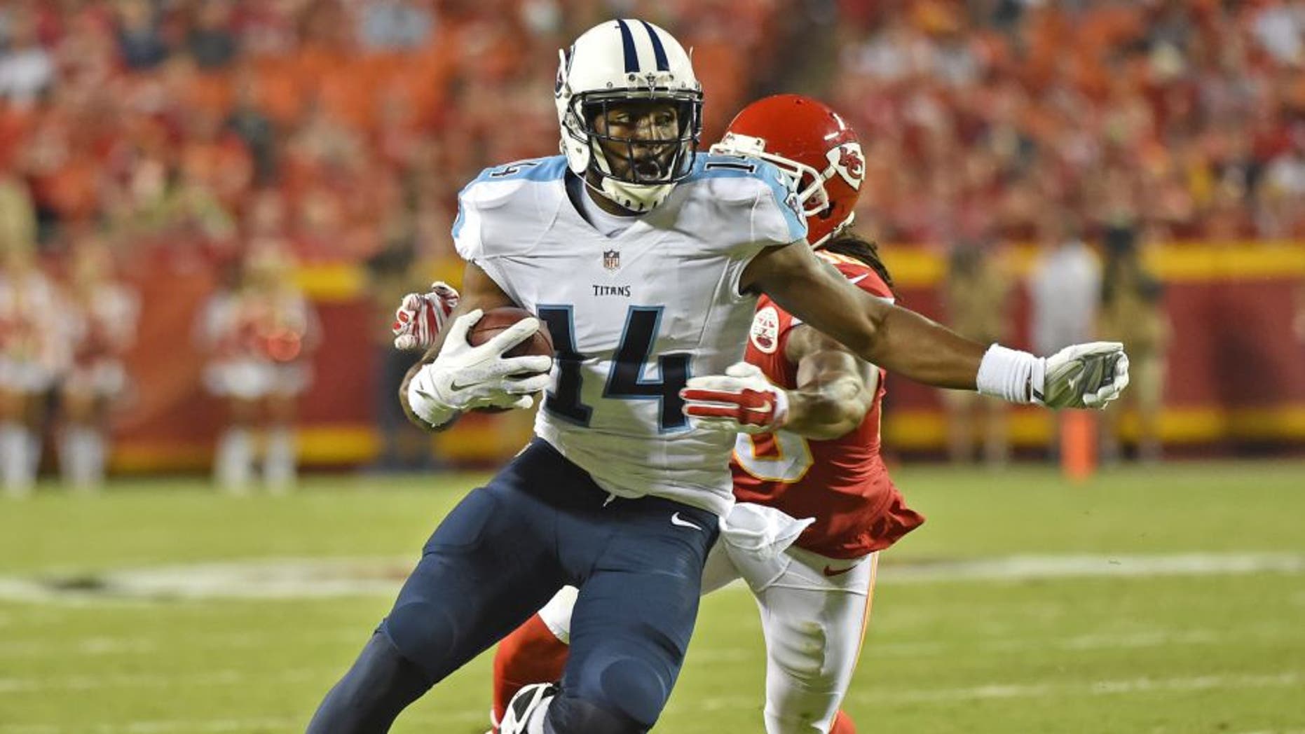 KANSAS CITY, MO - AUGUST 28: Wide receiver Hakeem Nicks #14 of the Tennessee Titans runs up field against defensive back Jamell Fleming #30 of the Kansas City Chiefs during the first half of a preseason game at Arrowhead Stadium on August 28, 2015 in Kansas City, Missouri. (Photo by Peter G. Aiken/Getty Images)