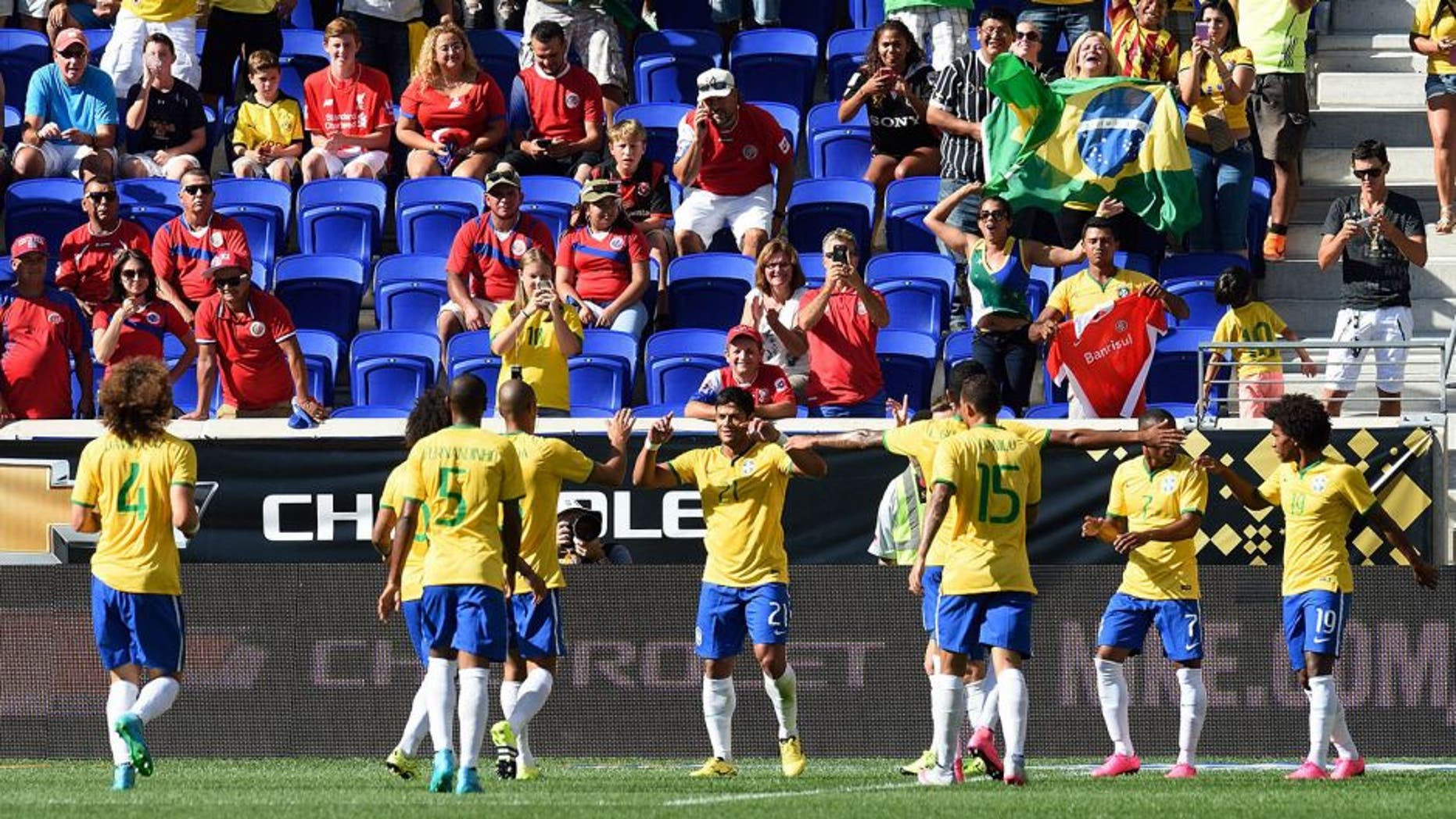 Brazil's Hulk (21) is congratulated by teammates after scoring a goal during the friendly match between Brazil and Costa Rica on September 5, 2015 at Red Bulls Arena in Harrison, New Jersey. AFP PHOTO/DON EMMERT (Photo credit should read DON EMMERT/AFP/Getty Images)