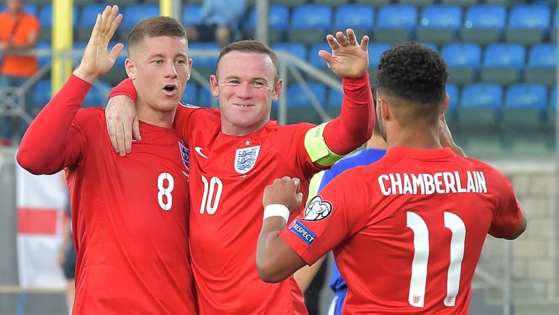 England's midfielder Ross Barkley (L) celebrates with England's forward Wayne Rooney (C) and England's forward Alex Oxlade Chamberlain after scoring during the EURO 2016 qualifying football match San Marino vs England at the San Marino stadium in Serravalle on September 5, 2015. AFP PHOTO / VINCENZO PINTO (Photo credit should read VINCENZO PINTO/AFP/Getty Images)