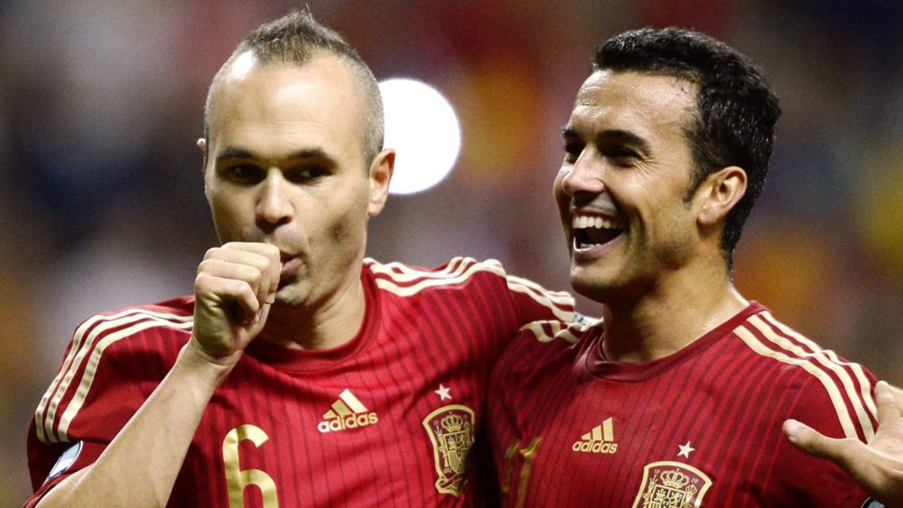 Spain's midfielder Andres Iniesta (L) celebrates with Spain's forward Pedro Rodriguez after scoring a goal during the Euro 2016 qualifying football match Spain vs Slovakia at the Carlos Tartiere stadium in Oviedo on September 5, 2015. AFP PHOTO/ MIGUEL RIOPA (Photo credit should read MIGUEL RIOPA/AFP/Getty Images)