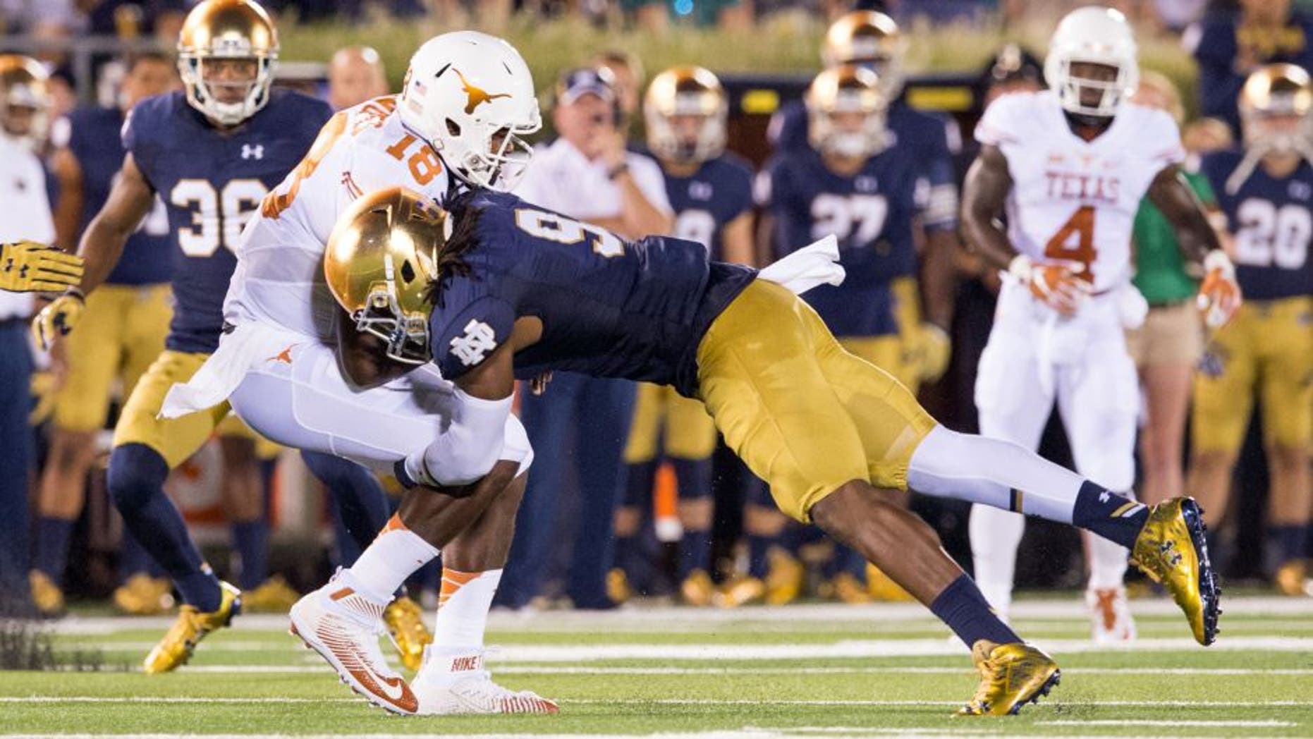 Sep 5, 2015; South Bend, IN, USA; Texas Longhorns quarterback Tyrone Swoopes (18) is tackled by Notre Dame Fighting Irish linebacker Jaylon Smith (9) in the second quarter at Notre Dame Stadium. Mandatory Credit: Matt Cashore-USA TODAY Sports