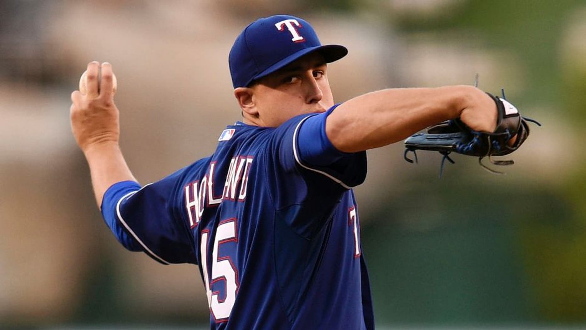 Sep 5, 2015; Anaheim, CA, USA; Texas Rangers starting pitcher Derek Holland (45) pitches against the Los Angeles Angels during the first inning at Angel Stadium of Anaheim. Mandatory Credit: Kelvin Kuo-USA TODAY Sports