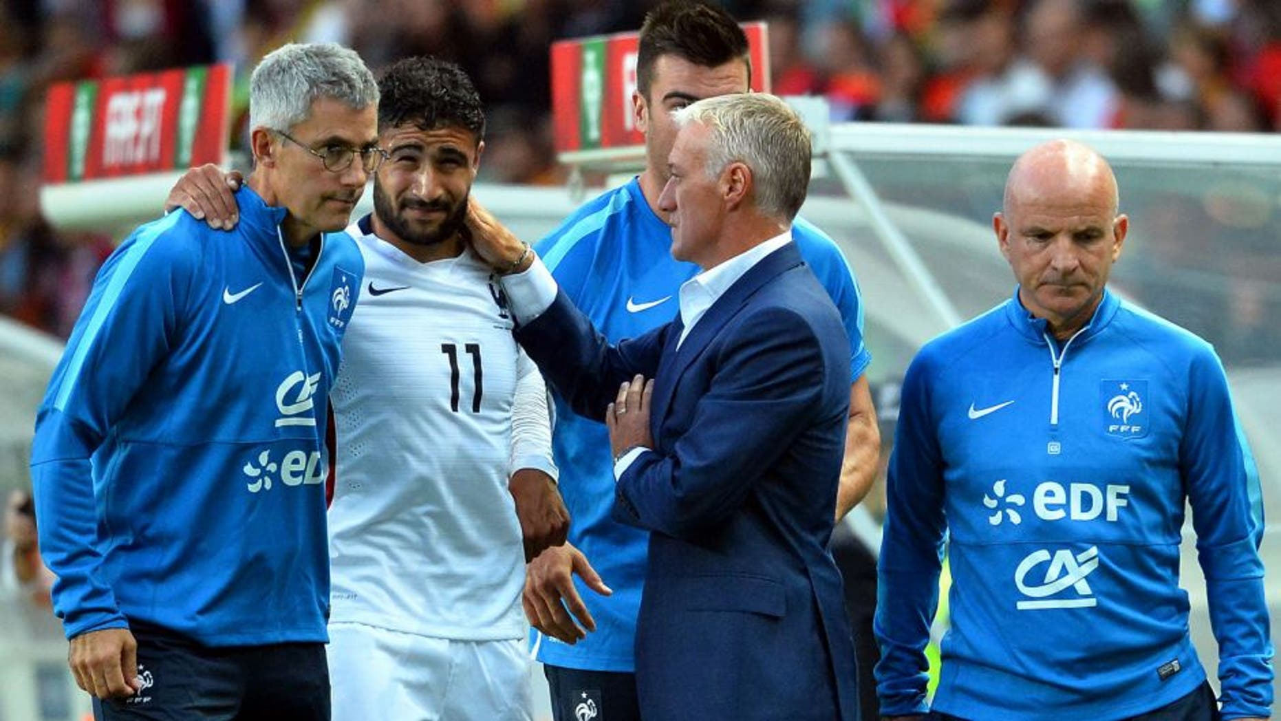France's forward Nabl Fekir (C) leaves the pitch after injury next to French doctor Franck Le Gall (L), head coach Didier Deschamps and assistant coach Guy Stephan during the Euro 2016 friendly football match Portugal vs France at the Jose Alvalade stadium in Lisbon on September 4, 2015. France won 0-1. AFP PHOTO/ FRANCK FIFE (Photo credit should read FRANCK FIFE/AFP/Getty Images)