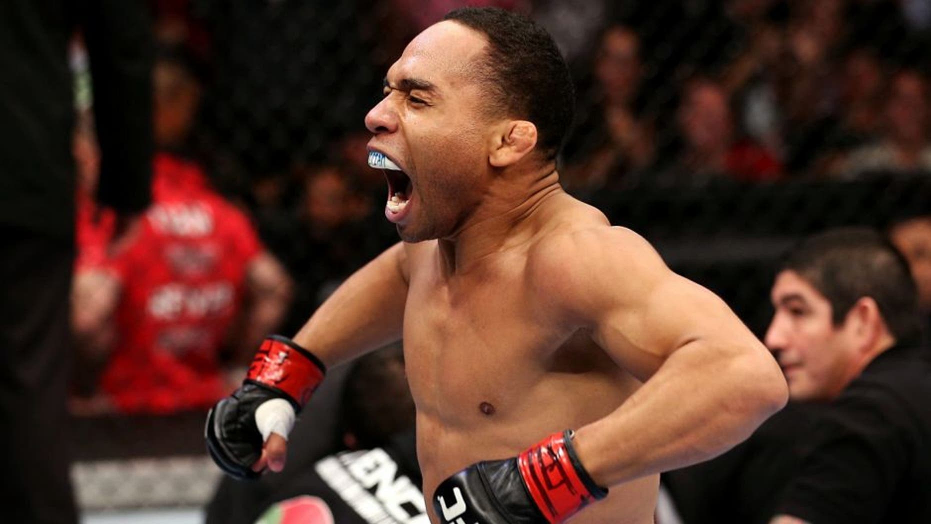 HOUSTON, TEXAS - OCTOBER 19: (L-R) John Dodson celebrates after defeating Darrell Montague by knockout in their UFC flyweight bout at the Toyota Center on October 19, 2013 in Houston, Texas. (Photo by Nick Laham/Zuffa LLC/Zuffa LLC via Getty Images)