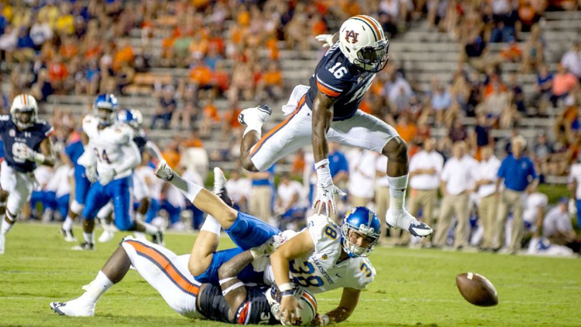 AUBURN, AL - SEPTEMBER 6: Linebacker JaViere Mitchell #16 of the Auburn Tigers leaps over linebacker Tre' Williams #30 of the Auburn Tigers and place kicker Michael Carrizosa #38 of the San Jose State Spartans to attempt to recover a fumble on September 6, 2014 at Jordan-Hare Stadium in Auburn, Alabama. Auburn defeated San Jose State 59-13. (Photo by Michael Chang/Getty Images)