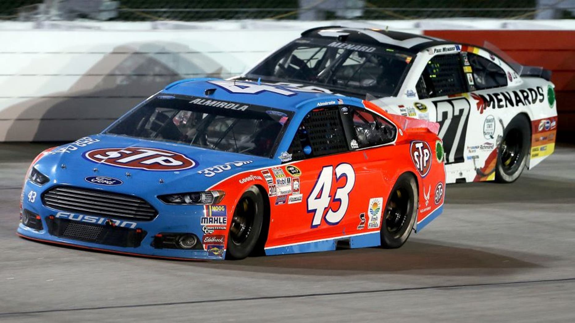 DARLINGTON, SC - SEPTEMBER 06: Aric Almirola, driver of the #43 STP Ford, races Paul Menard, driver of the #27 Moen/Menards Chevrolet, during the NASCAR Sprint Cup Series Bojangles' Southern 500 at Darlington Raceway on September 6, 2015 in Darlington, South Carolina. (Photo by Matt Hazlett/Getty Images)