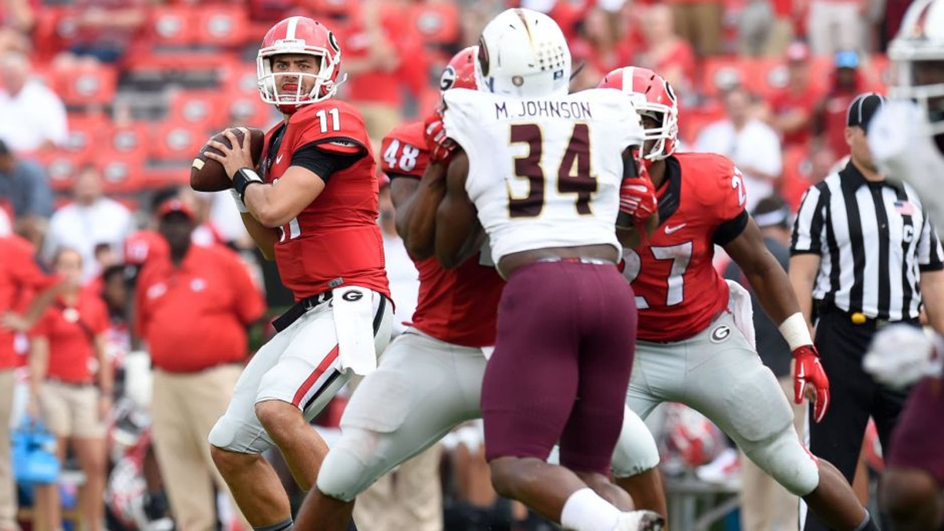 Sep 5, 2015; Athens, GA, USA; Georgia Bulldogs quarterback Greyson Lambert (11) throws a touchdown pass to wide receiver Malcolm Mitchell (not shown) against the Louisiana Monroe Warhawks during the second half at Sanford Stadium. Georgia defeated Louisiana Monroe 51-14 in a game shortened by thunder storms. Mandatory Credit: Dale Zanine-USA TODAY Sports