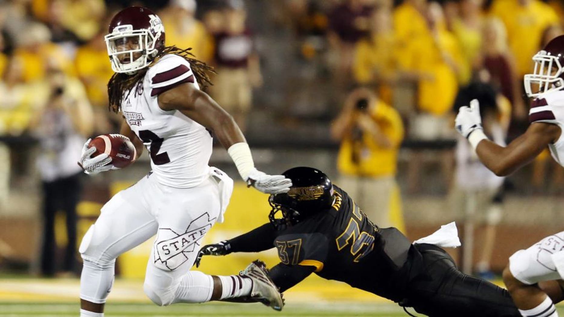 Sep 5, 2015; Hattiesburg, MS, USA; Mississippi State Bulldogs running back Ashton Shumpert (32) runs away from Southern Miss Golden Eagles linebacker Sherrod Ruff (37) in the first quarter of their game at M.M. Roberts Stadium. Mandatory Credit: Chuck Cook-USA TODAY Sports