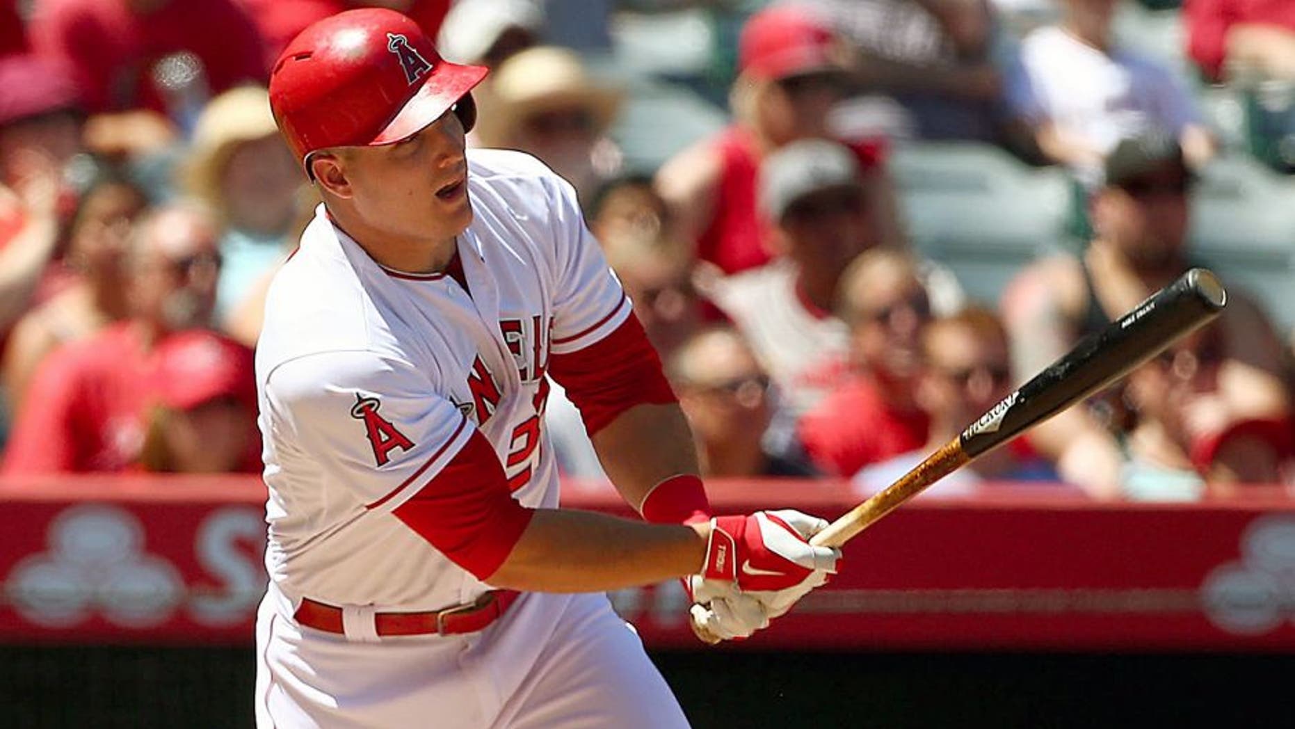 ANAHEIM, CA - SEPTEMBER 06: Mike Trout #27 of the Los Angeles Angels of Anaheim hits a sacrifice fly to center in the second inning as teammate Albert Pujols #5 watches from the on-deck circle during the MLB game against the Texas Rangers at Angel Stadium of Anaheim on September 6, 2015 in Anaheim, California. (Photo by Victor Decolongon/Getty Images)