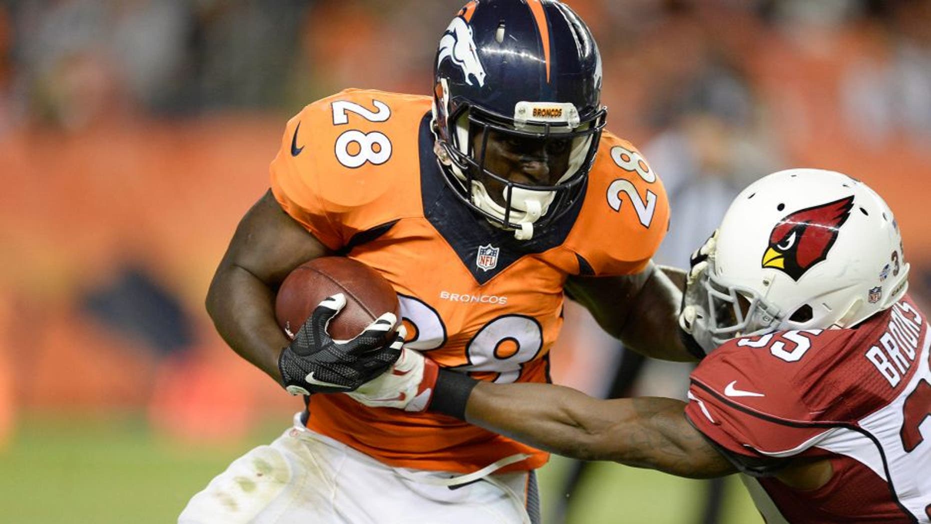 Sep 3, 2015; Denver, CO, USA; Denver Broncos running back Montee Ball (28) is tackled by Arizona Cardinals defensive back Cariel Brooks (35) in the third quarter of a preseason game at Sports Authority Field at Mile High. The Cardinals defeated the Broncos 22-20. Mandatory Credit: Ron Chenoy-USA TODAY Sports