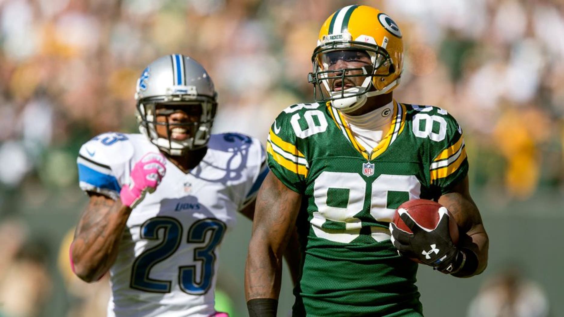 GREEN BAY, WI - OCTOBER 6: James Jones #89 of the Green Bay Packers runs during a 83 yard touchdown catch against the Chris Houston #23 of the Detroit Lions at Lambeau Field on October 6, 2013 in Green Bay, Wisconsin. The Packers defeated the Lions 22-9. (Photo Tom Lynn /Getty Images)