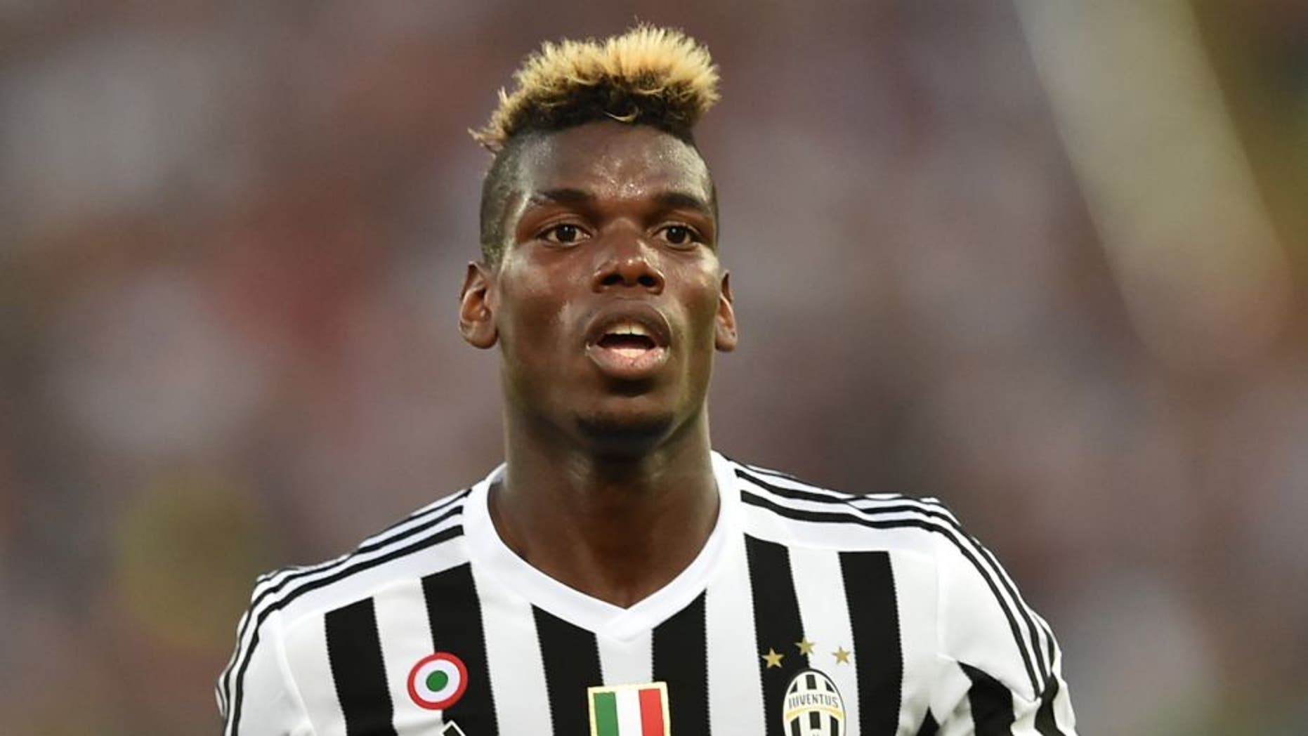Juventus' midfielder from France Paul Pogba reacts during the Italian Serie A football match AS Roma vs Juventus on August 30, 2015 at the Olympic stadium in Rome. AFP PHOTO / ALBERTO PIZZOLI (Photo credit should read ALBERTO PIZZOLI/AFP/Getty Images)