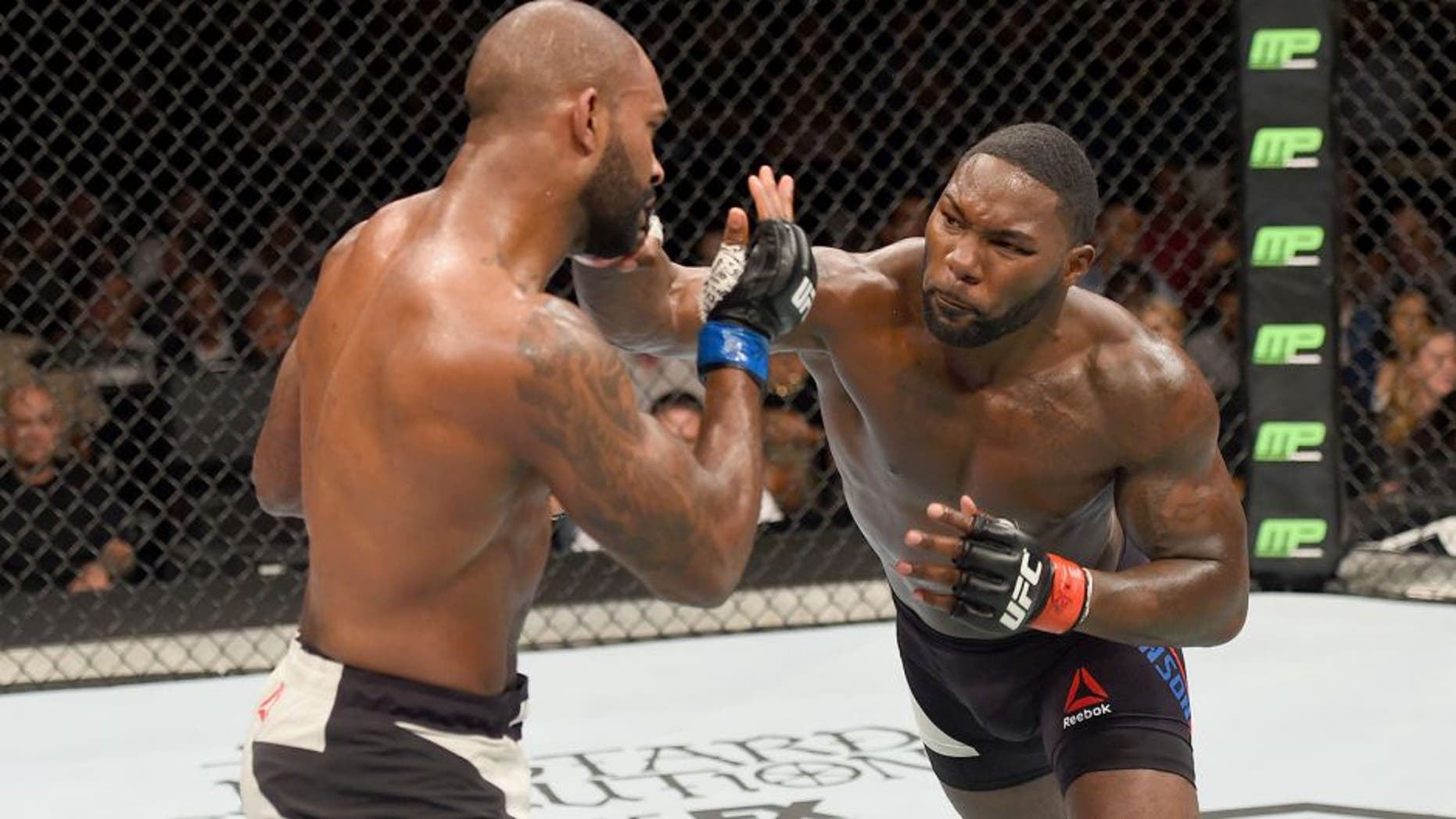 LAS VEGAS, NV - SEPTEMBER 05: (R-L) Anthony Johnson punches Jimi Manuwa in their light heavyweight bout during the UFC 191 event inside MGM Grand Garden Arena on September 5, 2015 in Las Vegas, Nevada. (Photo by Josh Hedges/Zuffa LLC/Zuffa LLC via Getty Images)