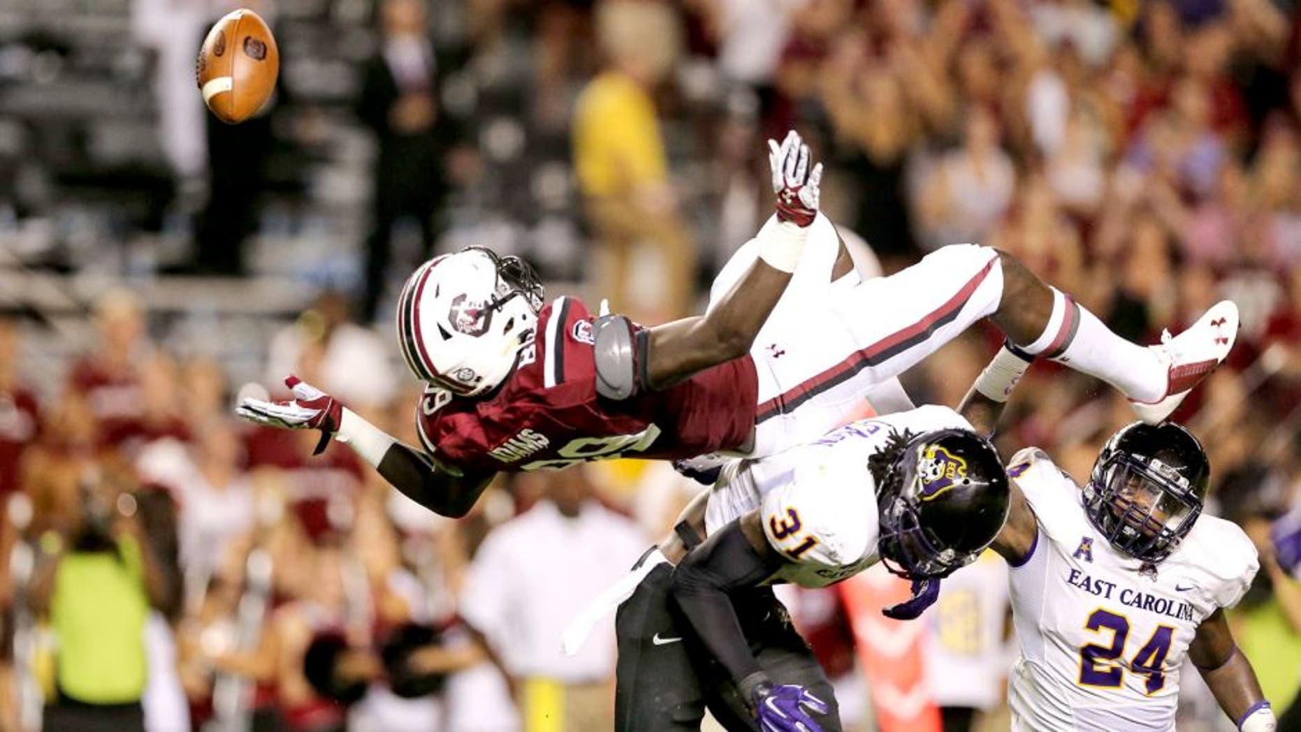 Sep 6, 2014; Columbia, SC, USA; South Carolina Gamecocks tight end Jerell Adams (89) is upended going for the reception by East Carolina Pirates defensive back Domonique Lennon (31) during game action between the South Carolina Gamecocks and East Carolina Pirates at Williams-Brice Stadium. Mandatory Credit: Jim Dedmon-USA TODAY Sports