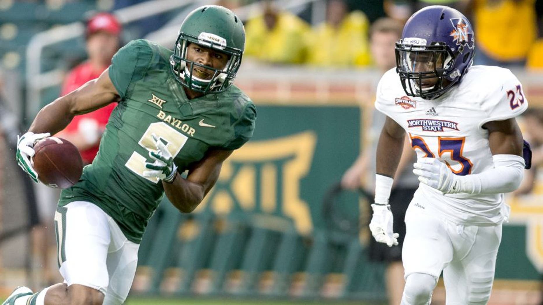 Sep 6, 2014; Waco, TX, USA; Baylor Bears wide receiver KD Cannon (9) catches a pass for a touchdown as Northwestern State Demons cornerback Fred Thomas (23) defends during the first quarter at McLane Stadium. Mandatory Credit: Jerome Miron-USA TODAY Sports