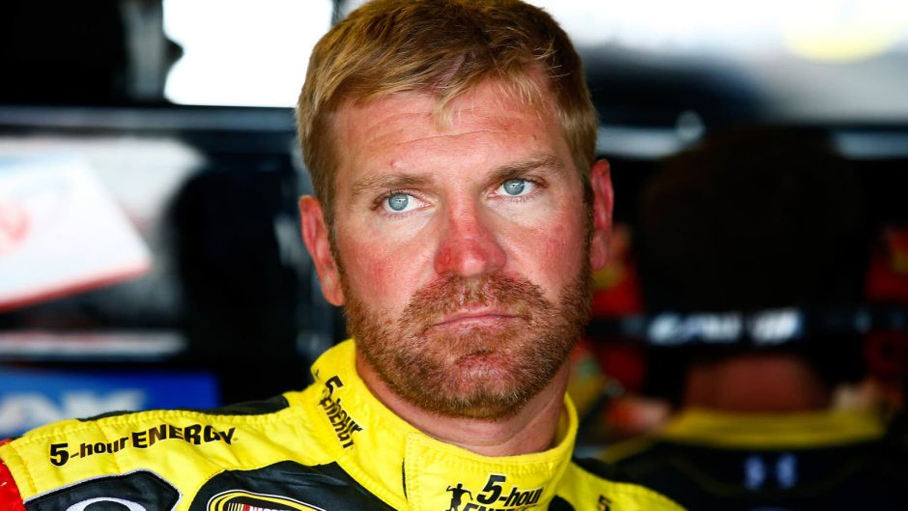 RICHMOND, VA - SEPTEMBER 05: Clint Bowyer, driver of the #15 5-hour ENERGY Toyota, stands in the garage area during practice for the NASCAR Sprint Cup Series Federated Auto Parts 400 at Richmond International Raceway on September 5, 2014 in Richmond, Virginia. (Photo by Jared Wickerham/Getty Images)