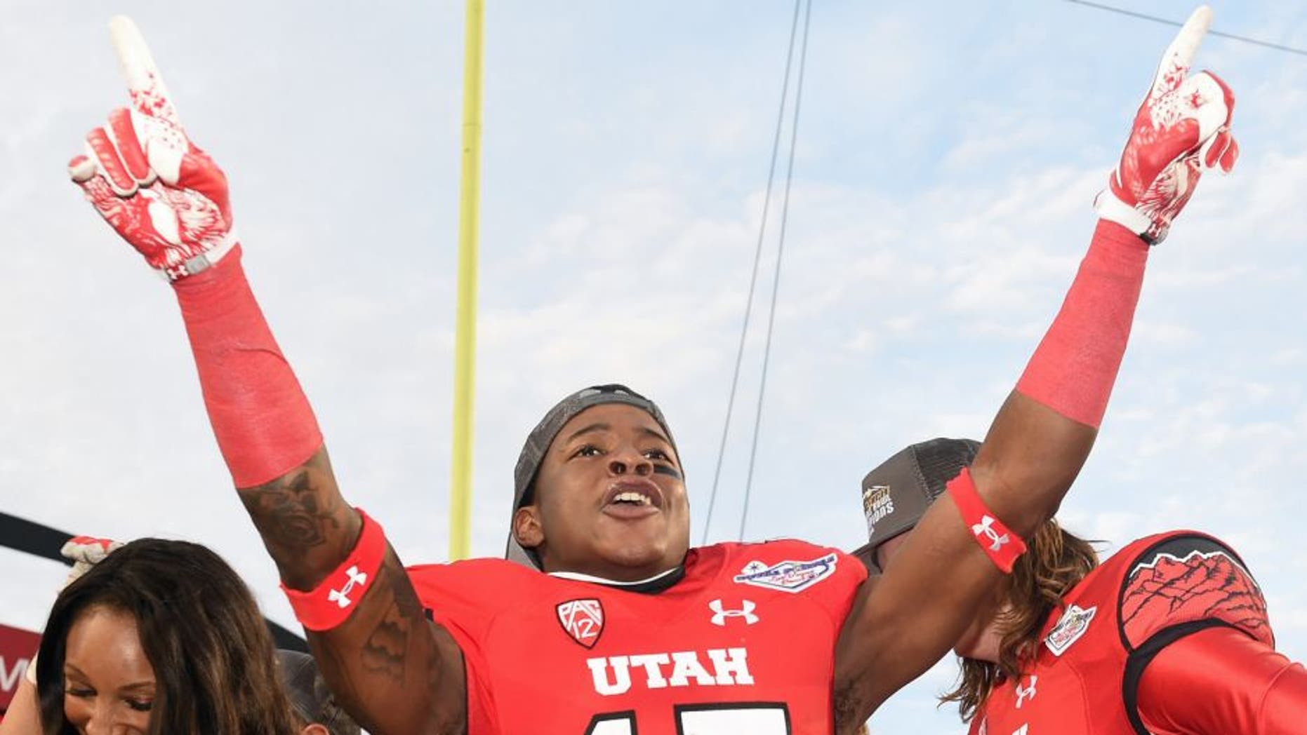 LAS VEGAS, NV - DECEMBER 20: Wide receiver Dominique Hatfield #15 of the Utah Utes celebrates after the team defeated the Colorado State Rams 45-10 in the Royal Purple Las Vegas Bowl at Sam Boyd Stadium on December 20, 2014 in Las Vegas, Nevada. (Photo by Ethan Miller/Getty Images)