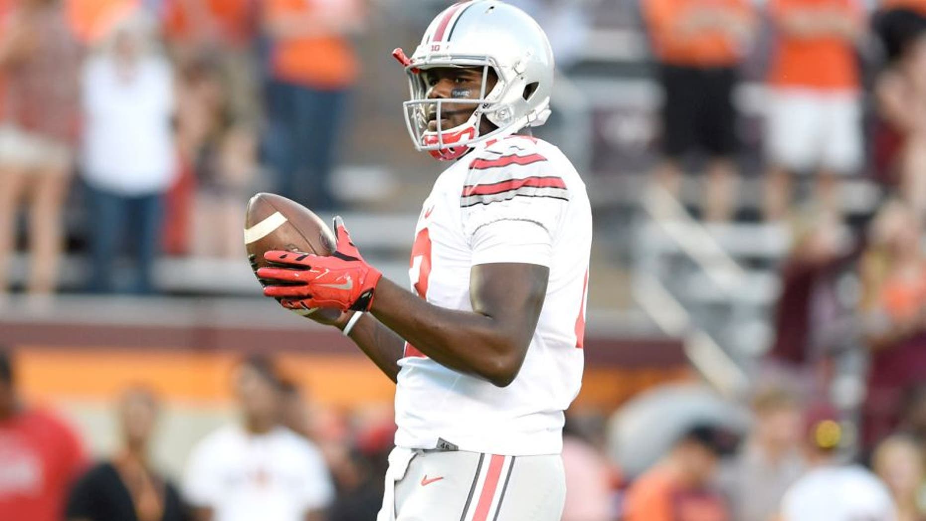 Sep 7, 2015; Blacksburg, VA, USA; Ohio State Buckeyes quarterback Cardale Jones (12) with the ball at Lane Stadium. Mandatory Credit: Bob Donnan-USA TODAY Sports