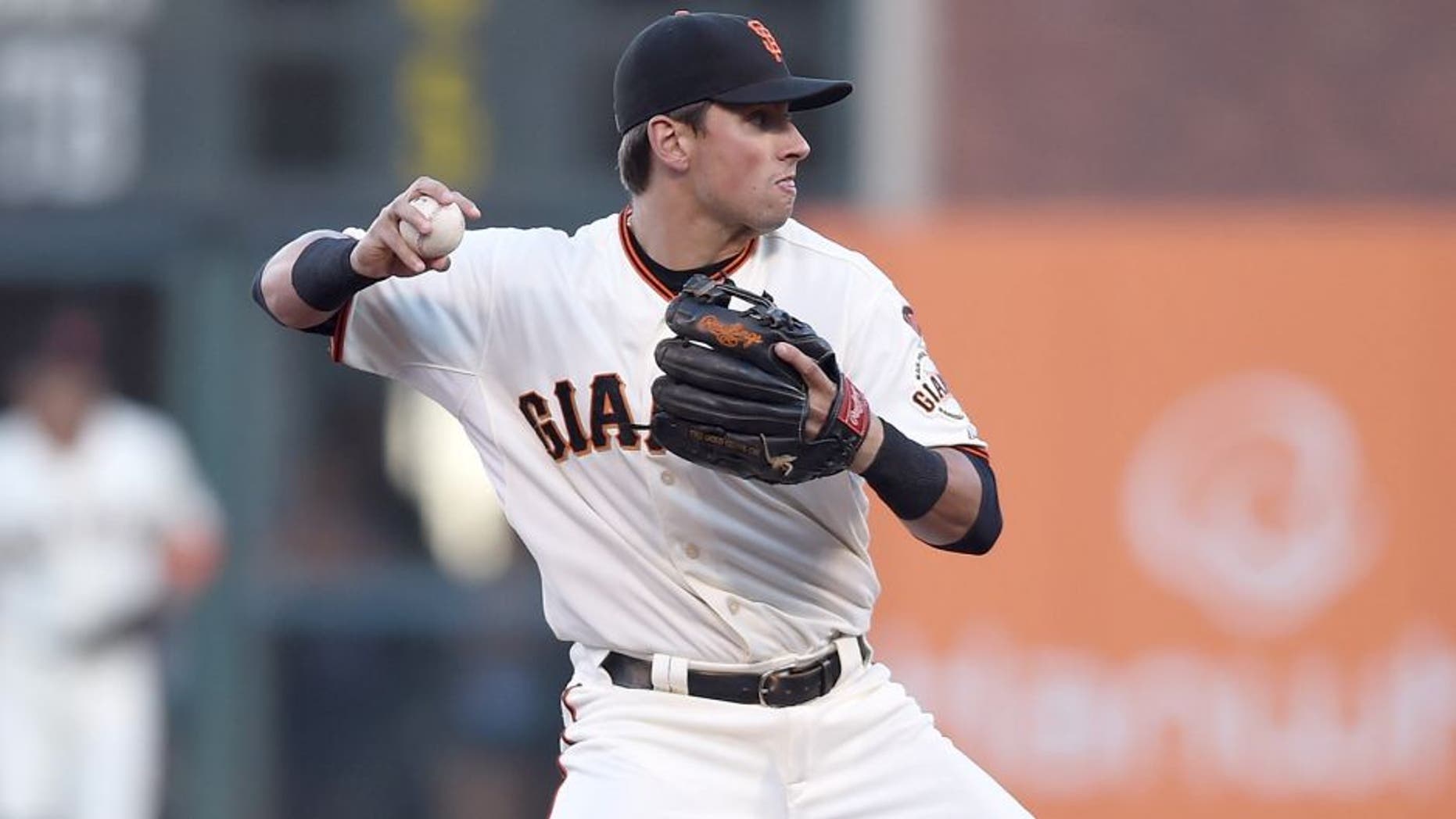 SAN FRANCISCO, CA - JULY 27: Joe Panik #12 of the San Francisco Giants looks to throw to first base and complete the double-play against the Milwaukee Brewers in the top of the first inning at AT&T Park on July 27, 2015 in San Francisco, California. (Photo by Thearon W. Henderson/Getty Images)