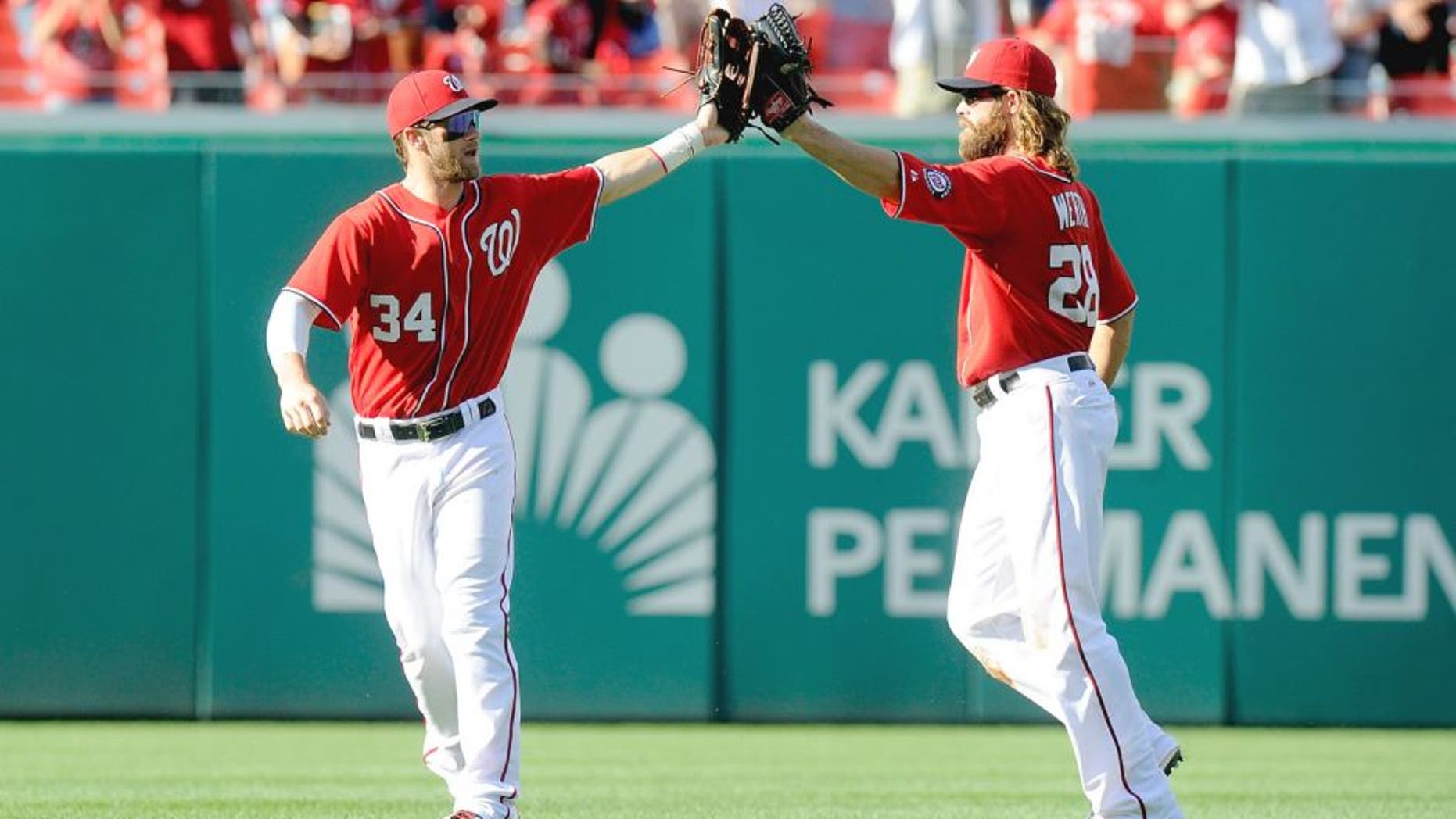 WASHINGTON, DC - AUGUST 24: Bryce Harper #34 of the Washington Nationals celebrates with Jayson Werth #28 after a victory against the San Francisco Giants at Nationals Park on August 24, 2014 in Washington, DC. (Photo by G Fiume/Getty Images)