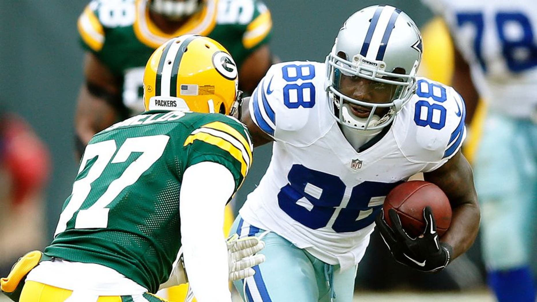 GREEN BAY, WI - JANUARY 11: Dez Bryant #88 of the Dallas Cowboys runs after a reception against the Green Bay Packers during the NFC Divisional Playoff game at Lambeau Field on January 11, 2015 in Green Bay, Wisconsin. The Packers defeated the Cowboys 26-21. (Photo by Joe Robbins/Getty Images)