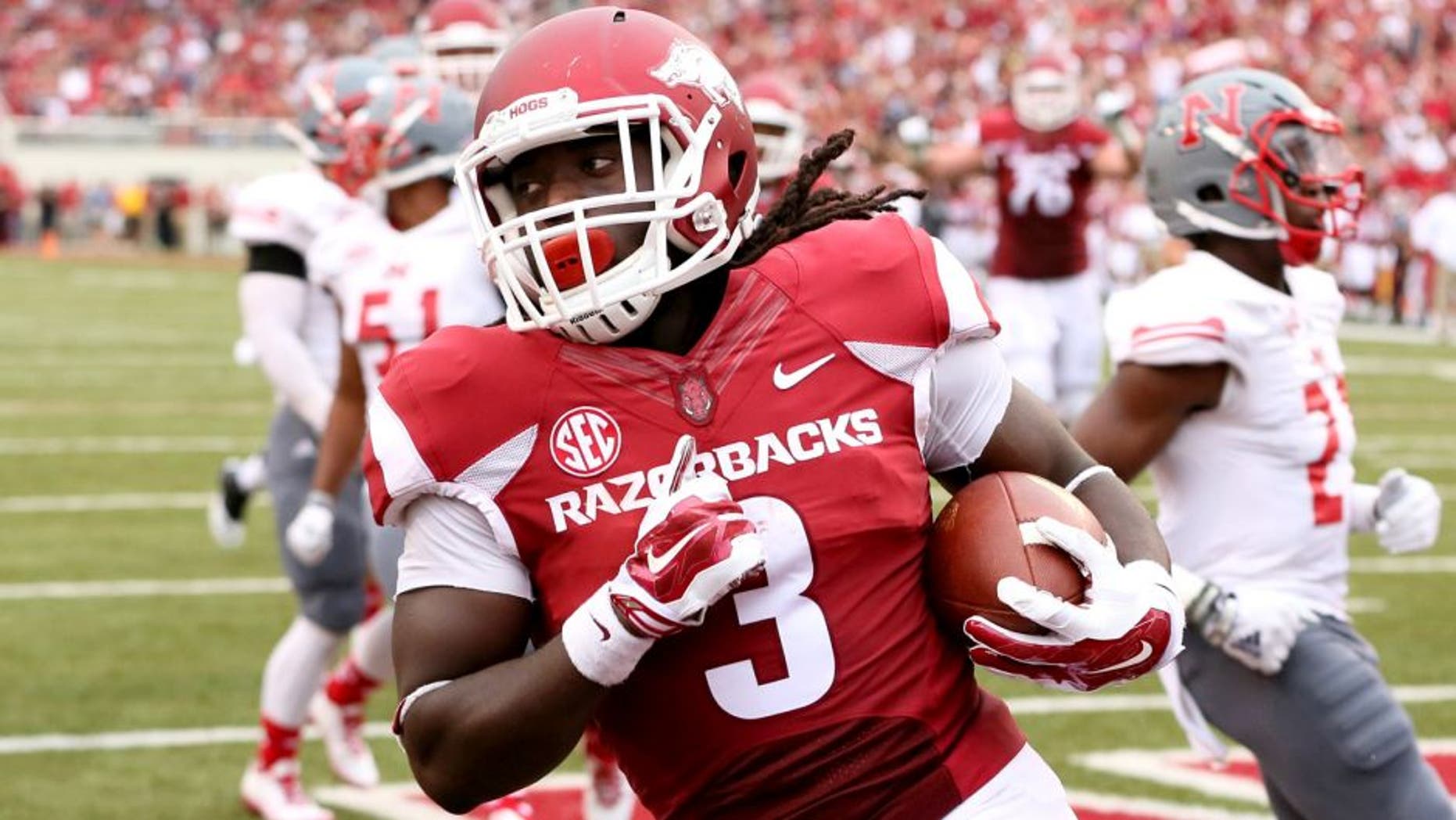 Sep 6, 2014; Fayetteville, AR, USA; Arkansas Razorbacks running back Alex Collins (3) rushes for a touchdown during the second quarter against the Nicholls State Colonels at Donald W. Reynolds Razorback Stadium. Mandatory Credit: Nelson Chenault-USA TODAY Sports