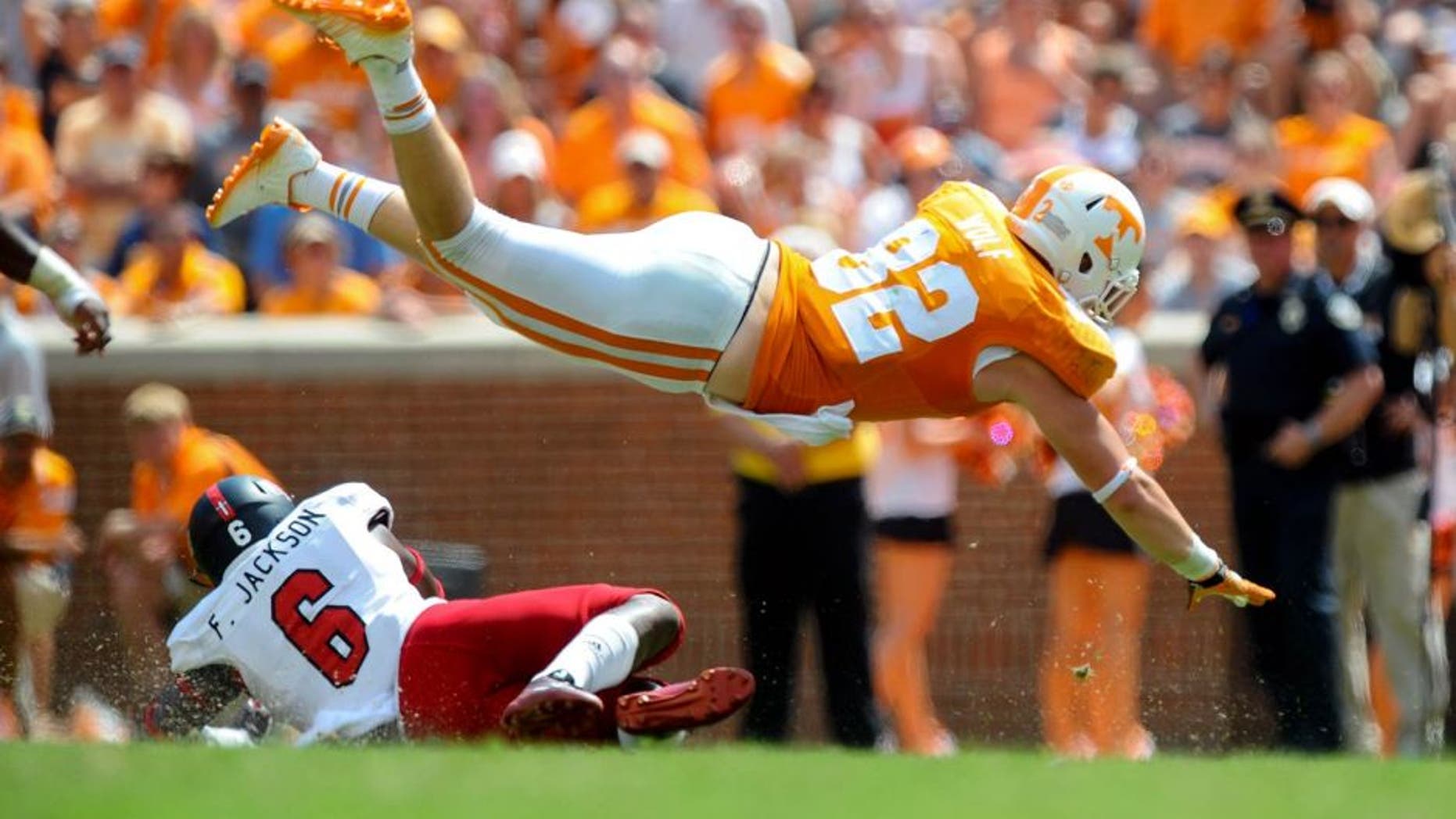 Sep 6, 2014; Knoxville, TN, USA; Tennessee Volunteers tight end Ethan Wolf (82) jumps over Arkansas State Red Wolves running back Frankie Jackson (6) during the second half at Neyland Stadium. Tennessee won 34 to 19. Mandatory Credit: Randy Sartin-USA TODAY Sports