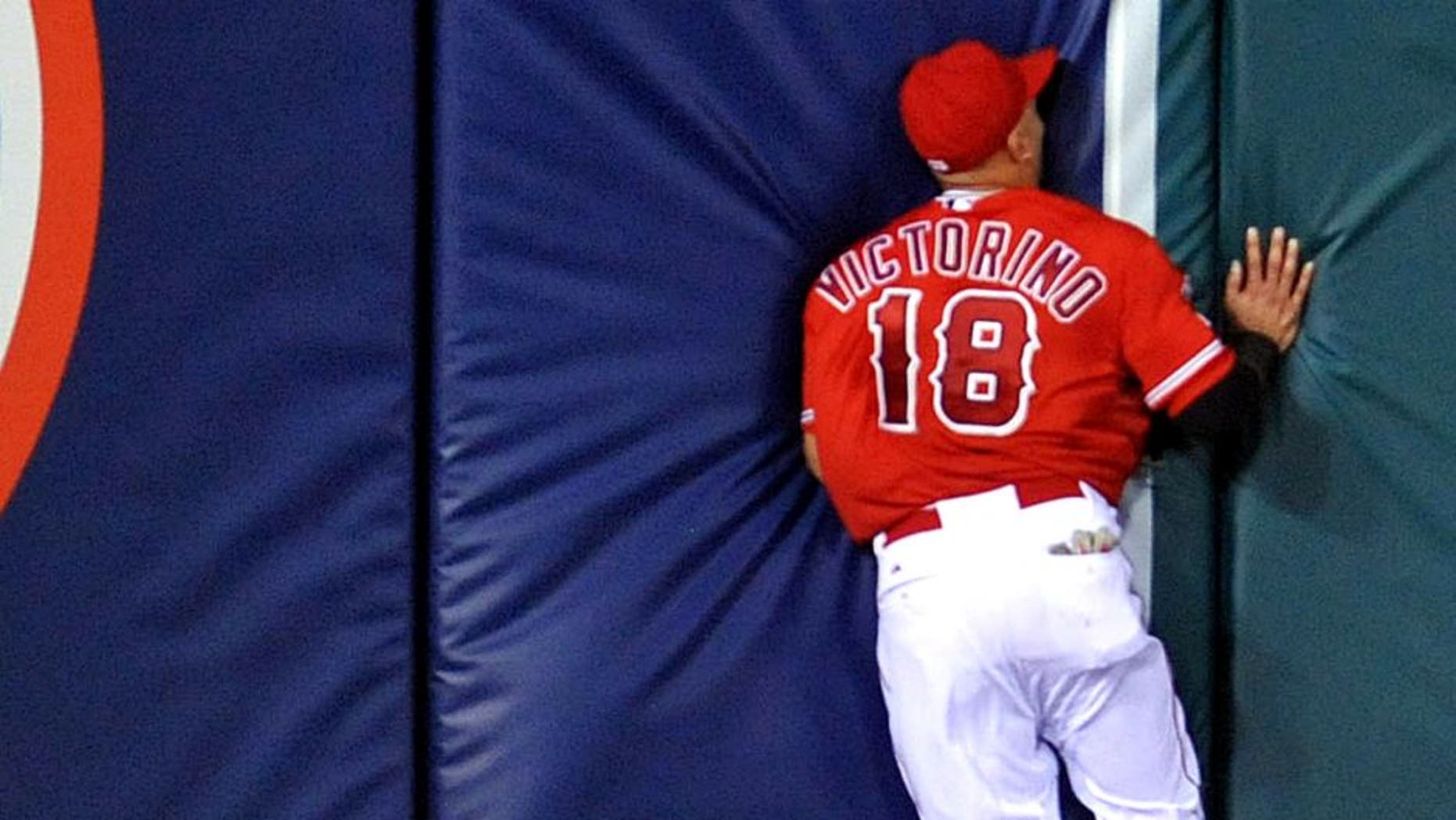 September 4, 2015; Anaheim, CA, USA; Los Angeles Angels left fielder Shane Victorino (18) runs into the wall after missing a fly ball in the seventh inning against the Texas Rangers at Angel Stadium of Anaheim. Mandatory Credit: Gary A. Vasquez-USA TODAY Sports