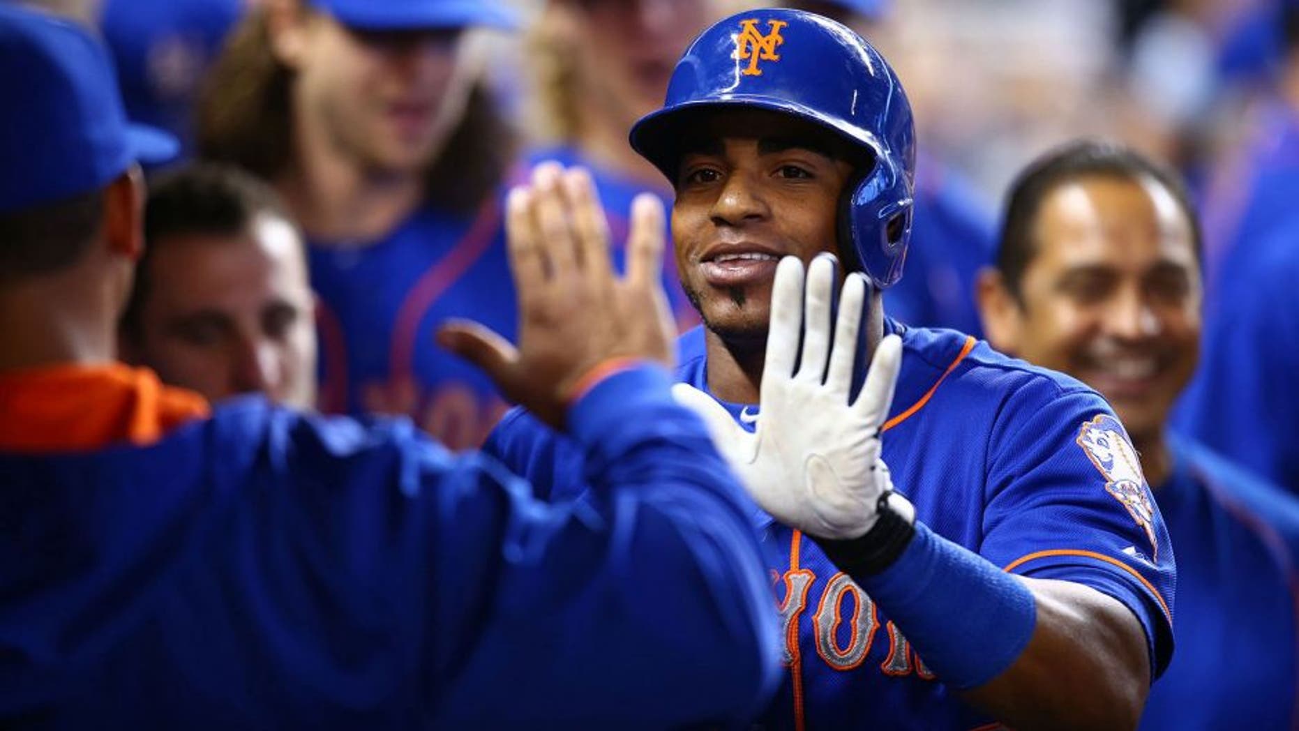 MIAMI, FL - SEPTEMBER 06: Yoenis Cespedes #52 of the New York Mets celebrates with teammates after hitting a solo home run during the first inning of the game against the Miami Marlins at Marlins Park on September 6, 2015 in Miami, Florida. (Photo by Rob Foldy/Getty Images)