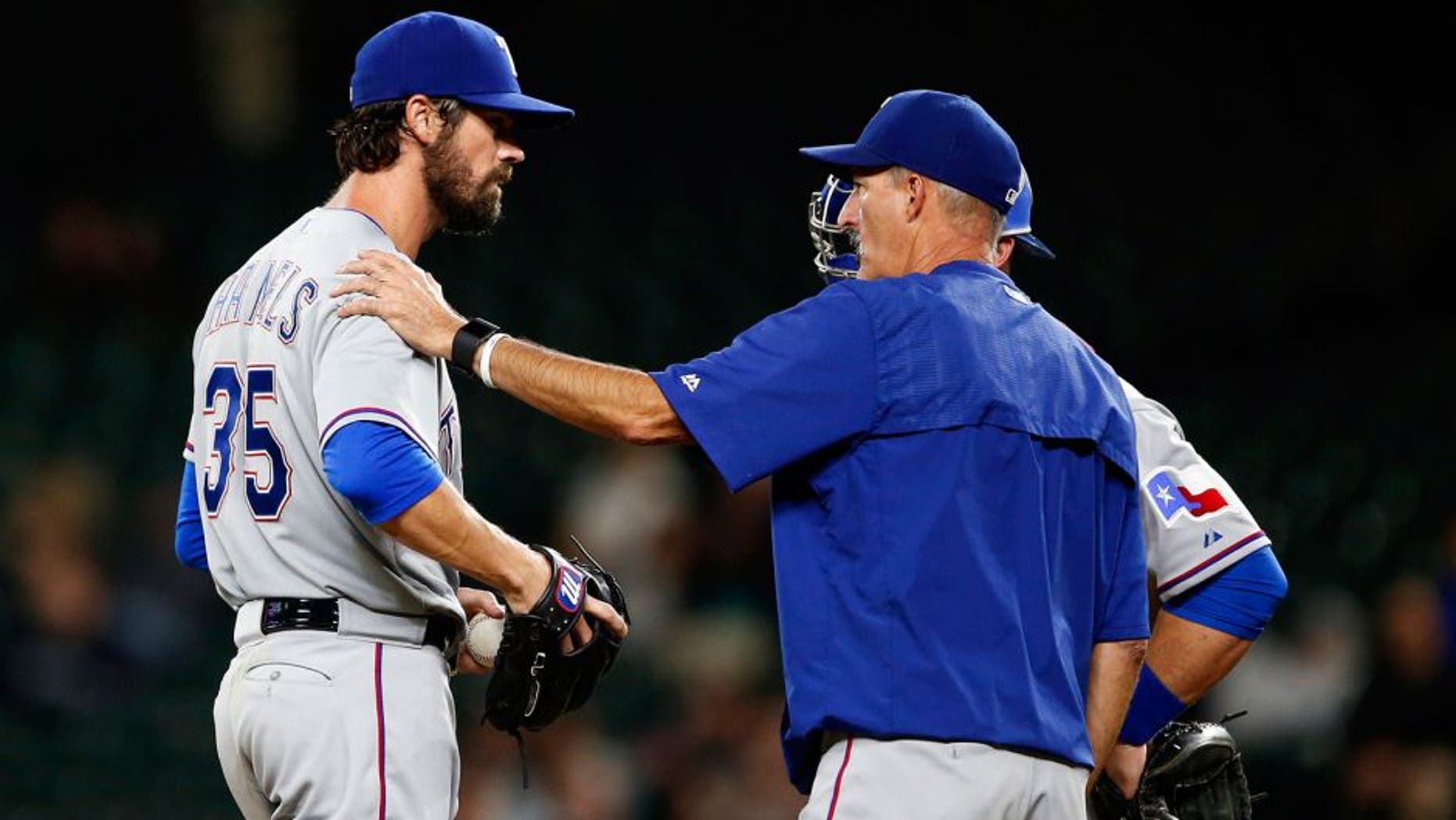 Sep 8, 2015; Seattle, WA, USA; Texas Rangers pitching coach Mike Maddux (31) talks with pitcher Cole Hamels (35) during the seventh inning against the Seattle Mariners at Safeco Field. Mandatory Credit: Joe Nicholson-USA TODAY Sports
