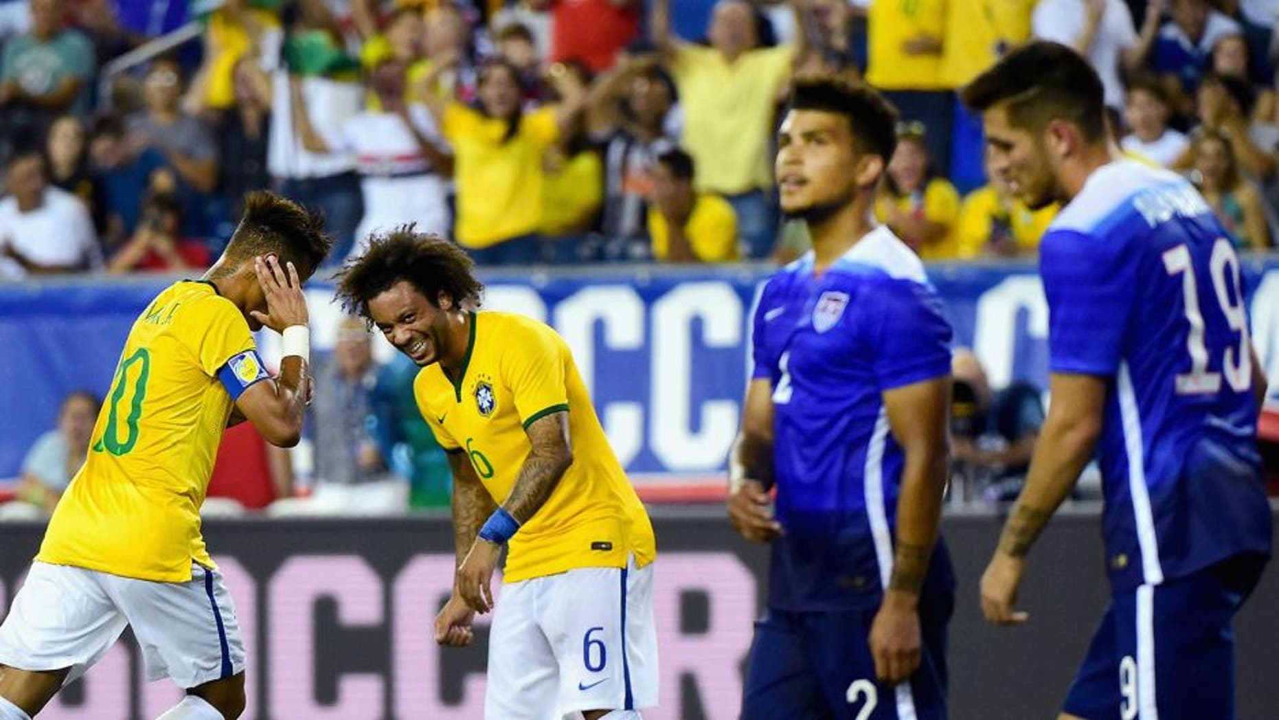 FOXBORO, MA - SEPTEMBER 08: Marcelo #6 and Neymar #10 of Brazil react after Neymar scored a goal during an international friendly against the United States at Gillette Stadium on September 8, 2015 in Foxboro, Massachusetts. (Photo by Billie Weiss/Getty Images)