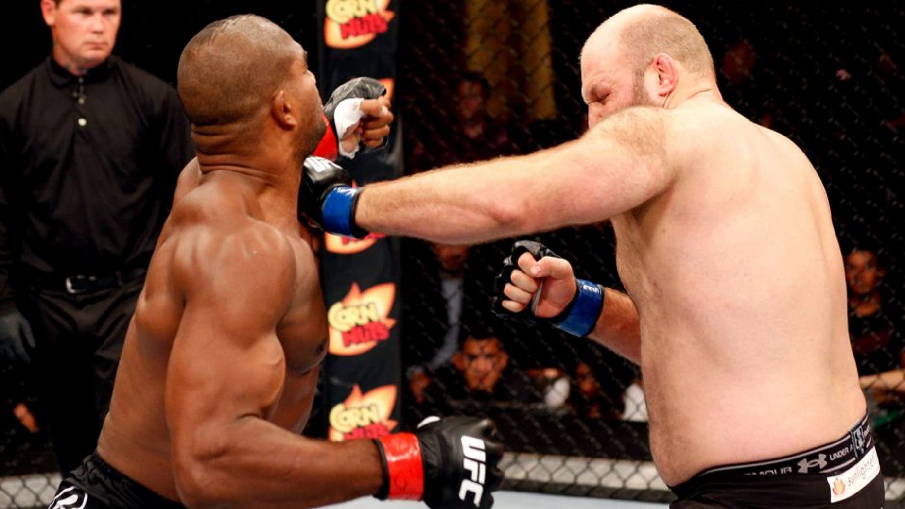 MASHANTUCKET, CT - SEPTEMBER 05: (R-L) Ben Rothwell punches Alistair Overeem in their heavyweight bout during the UFC Fight Night event at Foxwoods Resort Casino on September 5, 2014 in Mashantucket, Connecticut. (Photo by Josh Hedges/Zuffa LLC/Zuffa LLC via Getty Images)