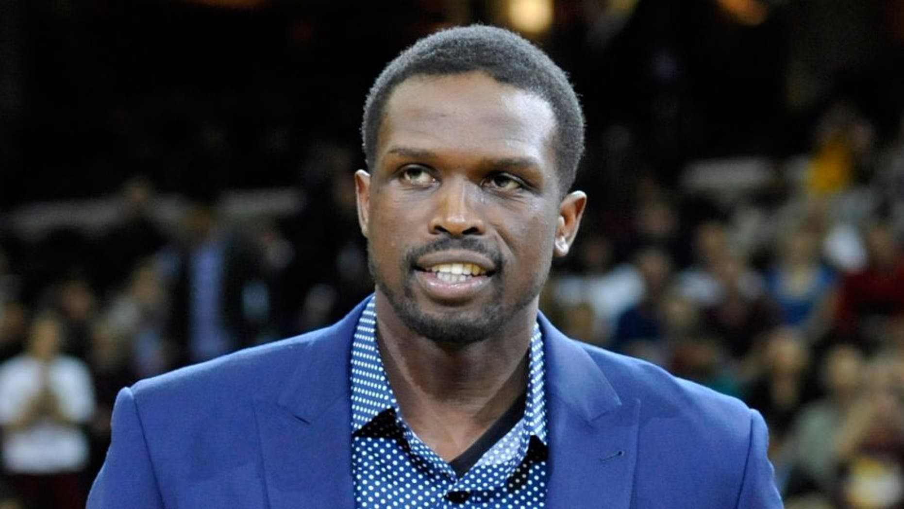Apr 12, 2014; Cleveland, OH, USA; Cleveland Cavaliers forward Luol Deng (left) is presented the J. Walter Kennedy Citizenship Award by sports writer Mary Schmitt Boyer prior to a game against the Brooklyn Nets at Quicken Loans Arena. The award is named after the second commissioner of the NBA and is presented annually by the Professional Basketball Writers Association to the player, coach or trainer who shows outstanding service and dedication to the community. Mandatory Credit: David Richard-USA TODAY Sports